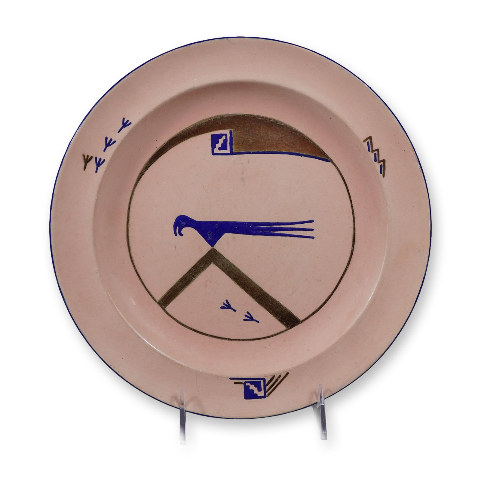 Wedgwood Hand Painted Ceramic Plate with Modernist Bird Design: This is a circular glazed earthenware plate manufactured by Wedgwood in England. It features a hand-painted modernist design executed on a salmon-pink ground. The decoration includes a stylized bird i