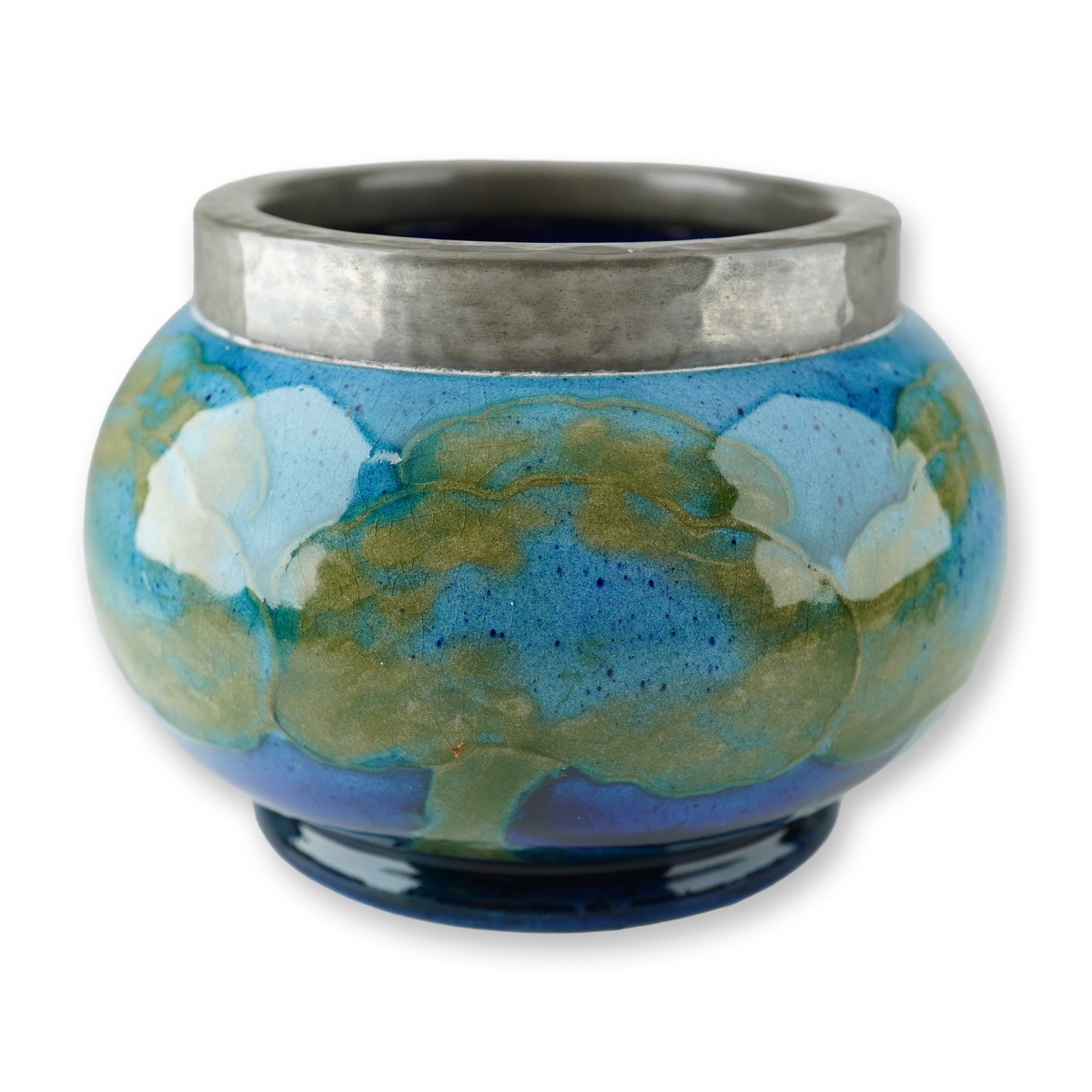 Moorcroft Pottery and Pewter Sugar Bowl, Moonlit Blue: A small bulbous-form open sugar bowl with a dark pewter metal rim and spout with hammered dimples. The body of the creamer is crafted by Moorcroft Pottery and features the blue and green landscape, Mo