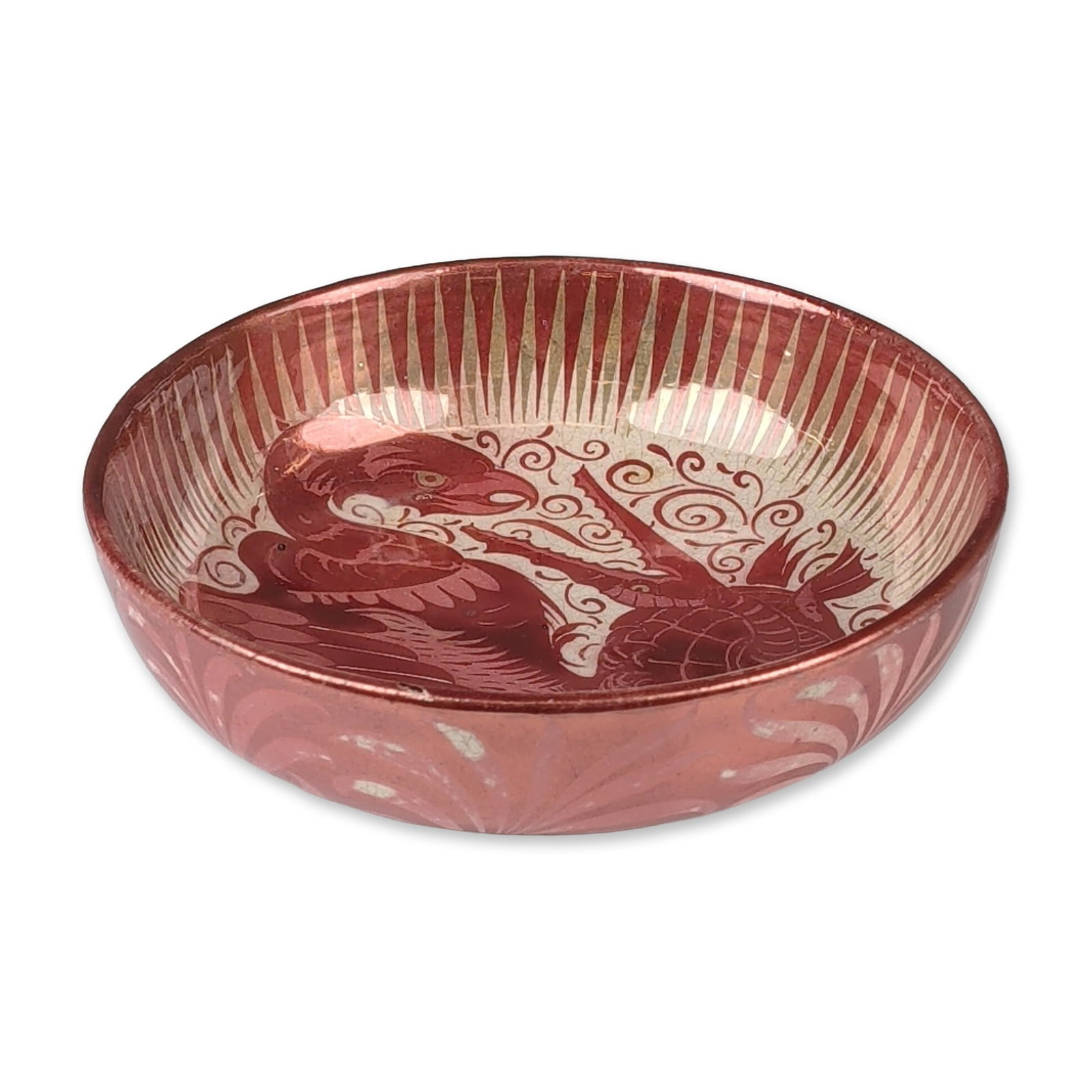 William De Morgan Fulham by Frederick Passenger Ruby Luster Vulture and Alligator Dish: Earthenware body featuring hand-painted ruby luster decoration over a cream ground. The interior well depicts a central zoomorphic scene of a large vulture with outspread wings engaged with a long-nec