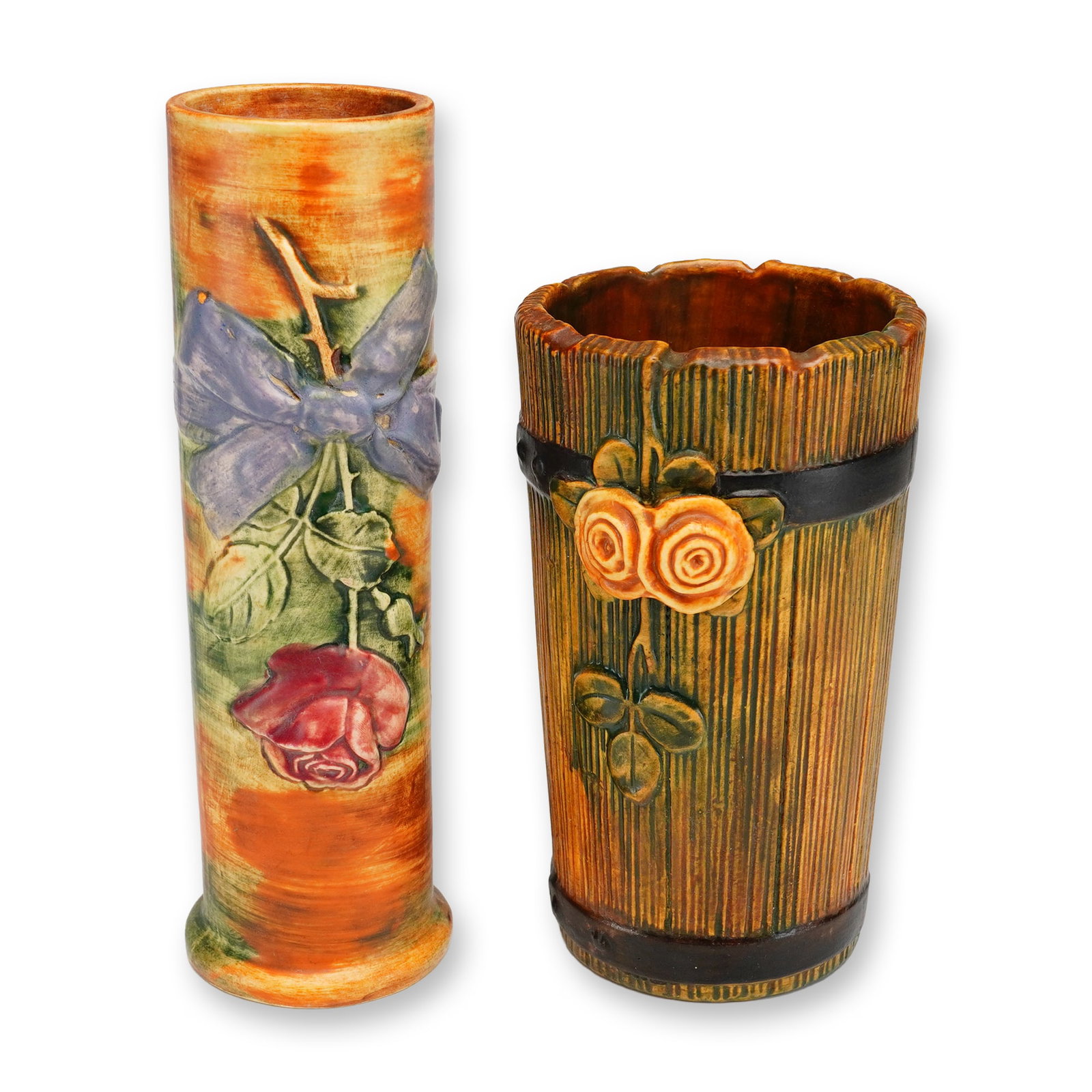 Two Weller Pottery Woodrose and Woodcraft Vases: Vases including a Woodcraft Flemish Rose pattern and a Woodrose pattern. The taller cylindrical Woodcraft vase is decorated with a relief-molded red rose and green foliage tied with a blue bow against