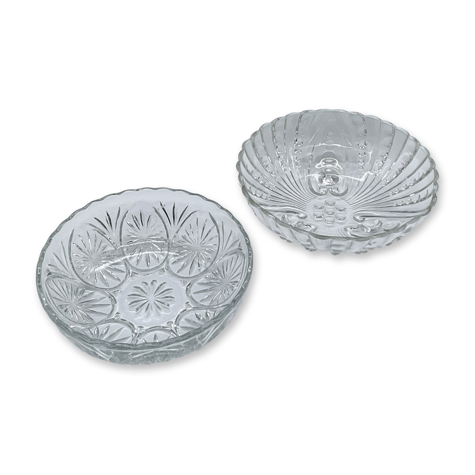 2pc Vintage Glass Serving Bowls: Two decorative glass serving bowls. One is footed with a unique burple pattern, measuring 3"H x 8"dia. The second bowl is etched with starbursts and has a scalloped edge. Measures 2.5"H x 8"dia.