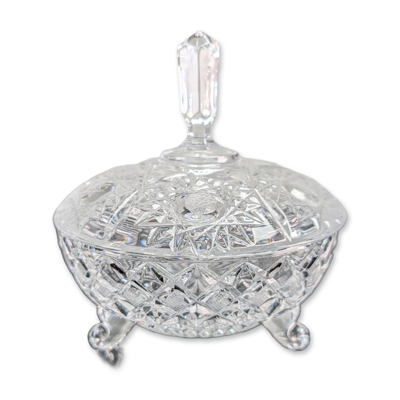 American Brilliant Style Cut Crystal Footed Candy Dish: American Brilliant Period style three-footed lidded bonbonniere in cut lead crystal. The piece features a domed lid topped with a faceted hexagonal finial, decorated with a central hobstar motif