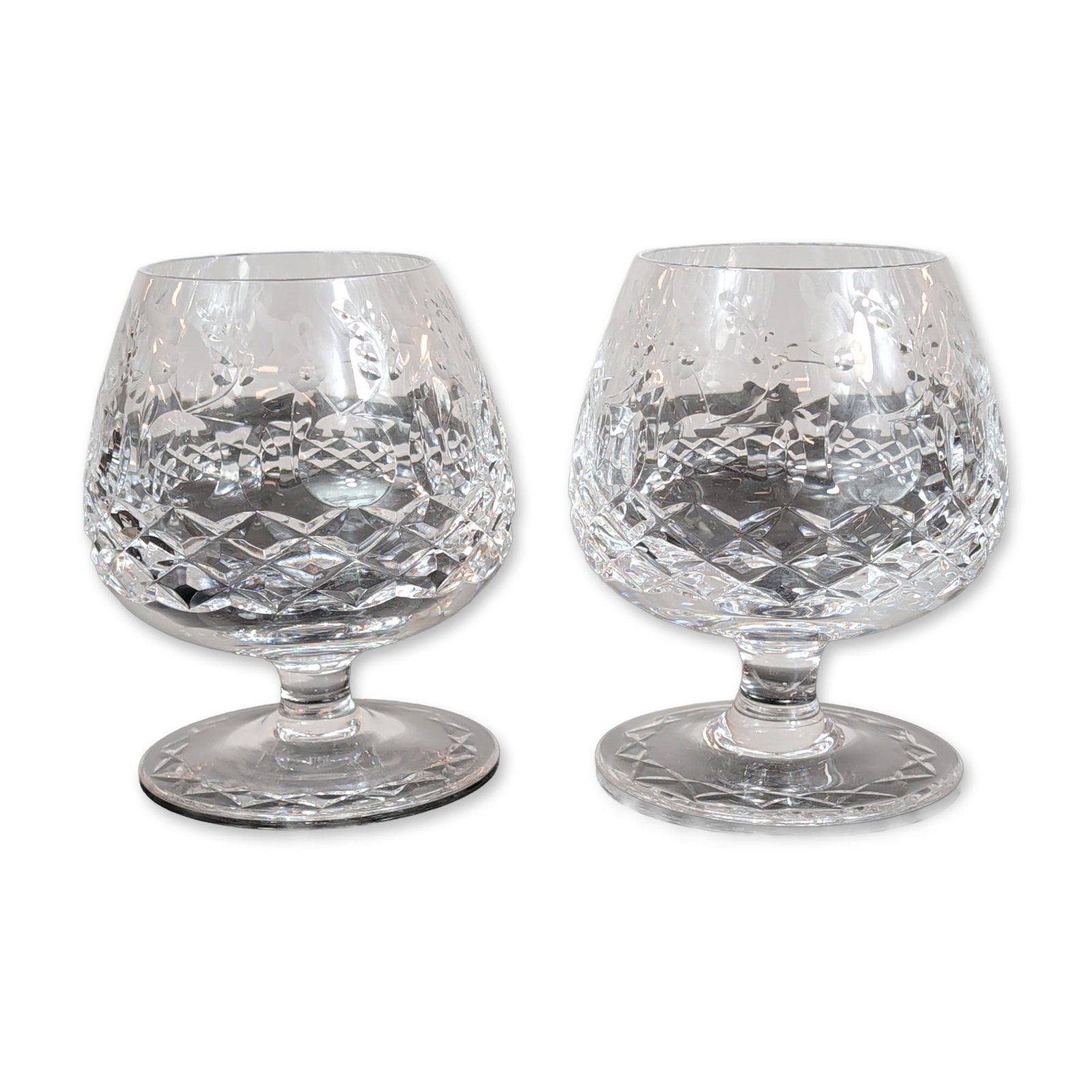 Pair of Rogaska Gallia Crystal Brandy Snifters: Rogaska. Pair of brandy snifters in lead crystal, decorated in the Gallia pattern. The design consists of a lower bowl with deep-cut criss-cross diamond facets and an upper section featuring an