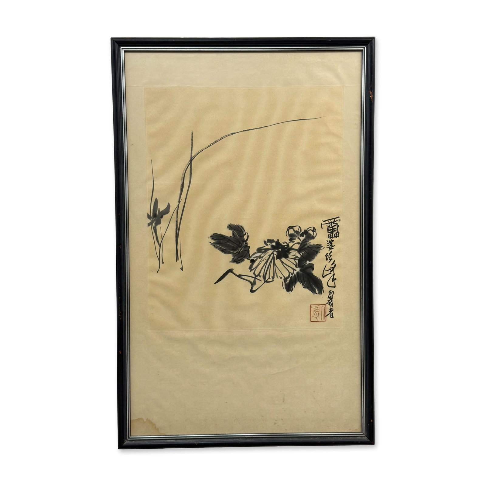 Chinese Ink Wash Painting of Chrysanthemum Attributed to Pan Tianshou: This 20th-century framed Chinese ink wash painting is attributed to the artist Xu Linlu (1897-1971). The work depicts a chrysanthemum blossom with dark, expressive leaves and slender blades of grass i