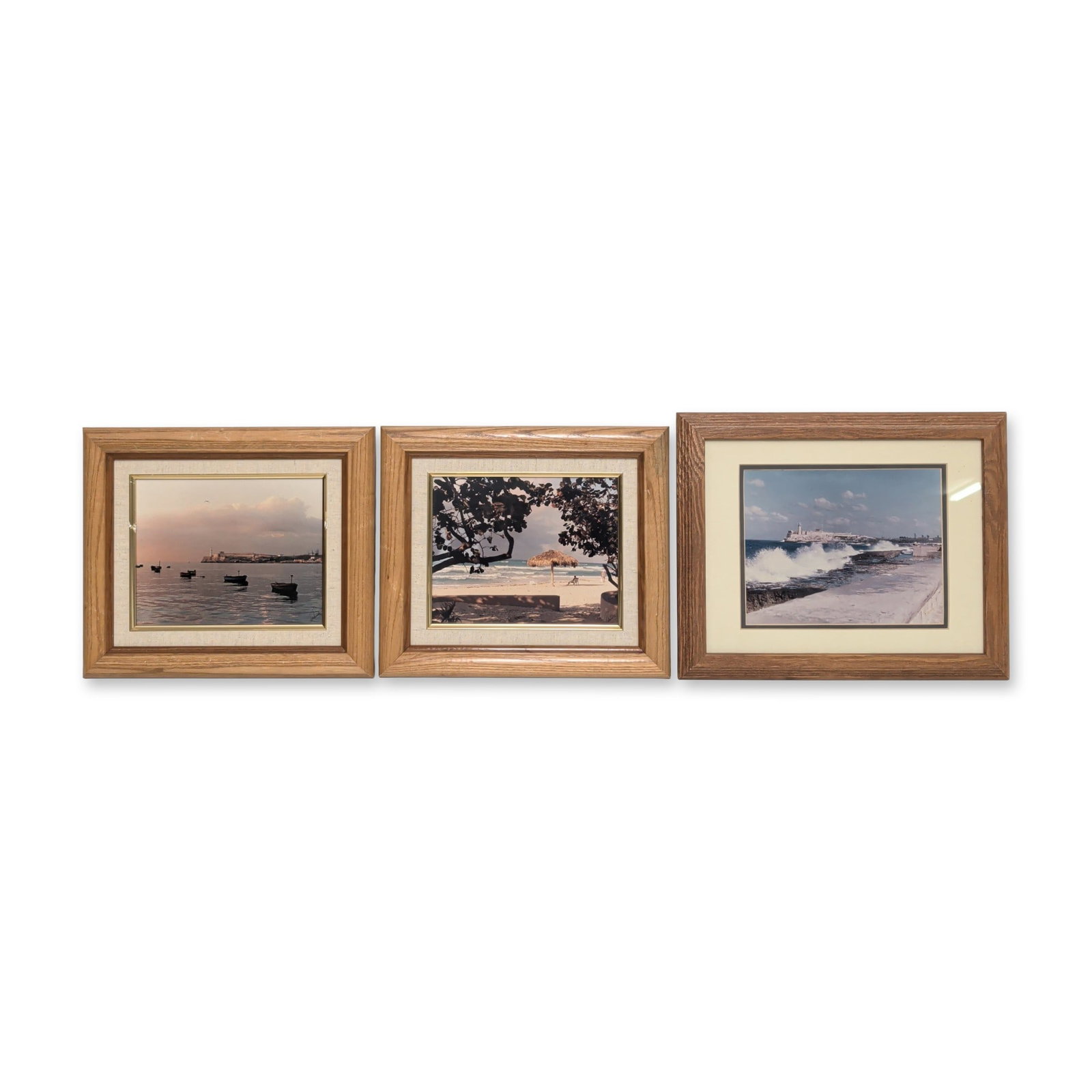 3pcs Chromogenic Prints on Paper, The Malecon, El Moro Havana & Cuban Beach Scene, Signed: Set of three framed chromogenic prints on paper depicting The Malecon Seawall and El Morro Castel in Havana and a Cuban beach scene. Housed in light brown wooden frames with cream mats, each bearing