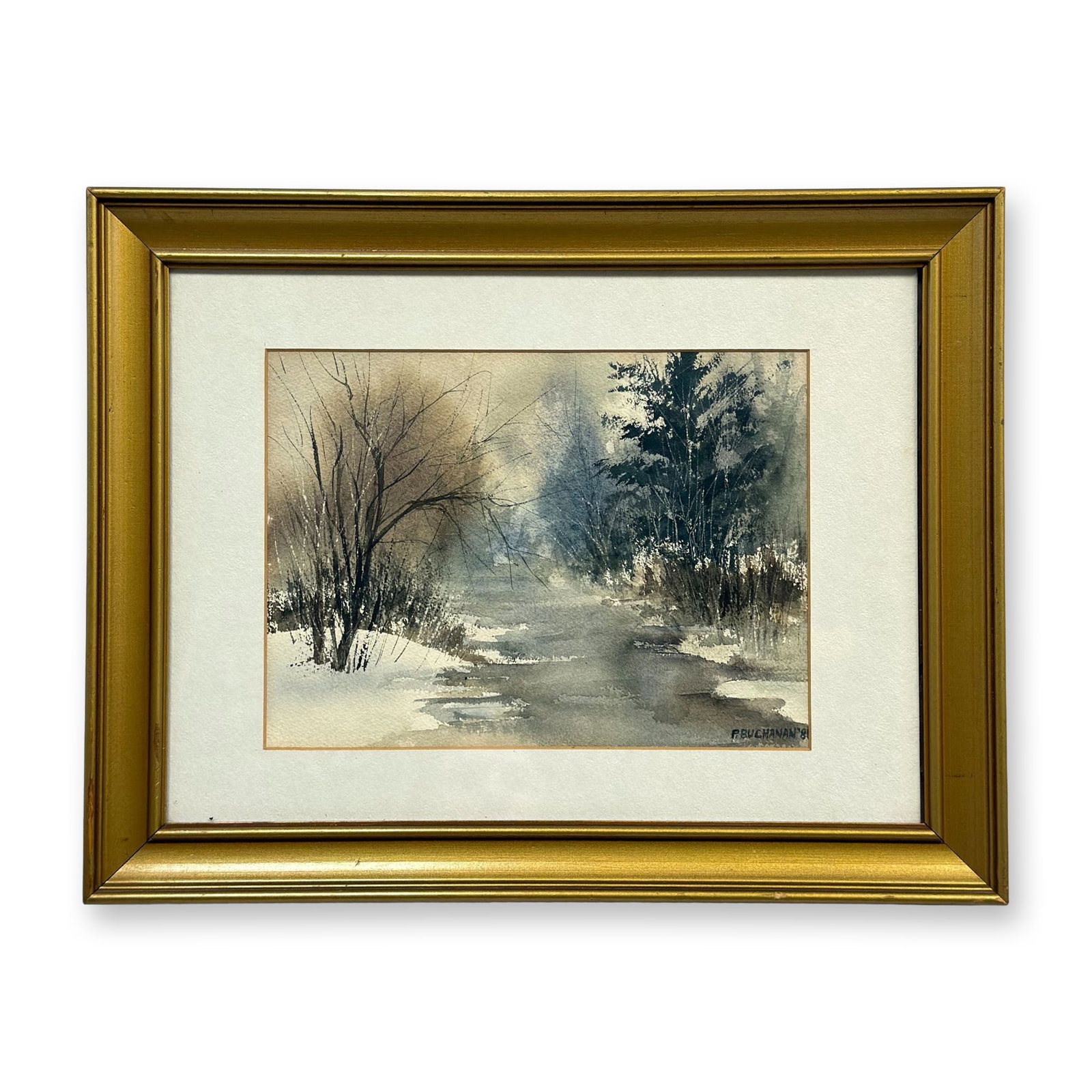 P. Buchanan (20th Century), Winter Stream Landscape, Original Watercolor Painting, 1981: This original watercolor painting on textured paper depicts an atmospheric winter landscape, featuring a winding stream set between snow-covered banks. The composition is flanked by bare deciduous