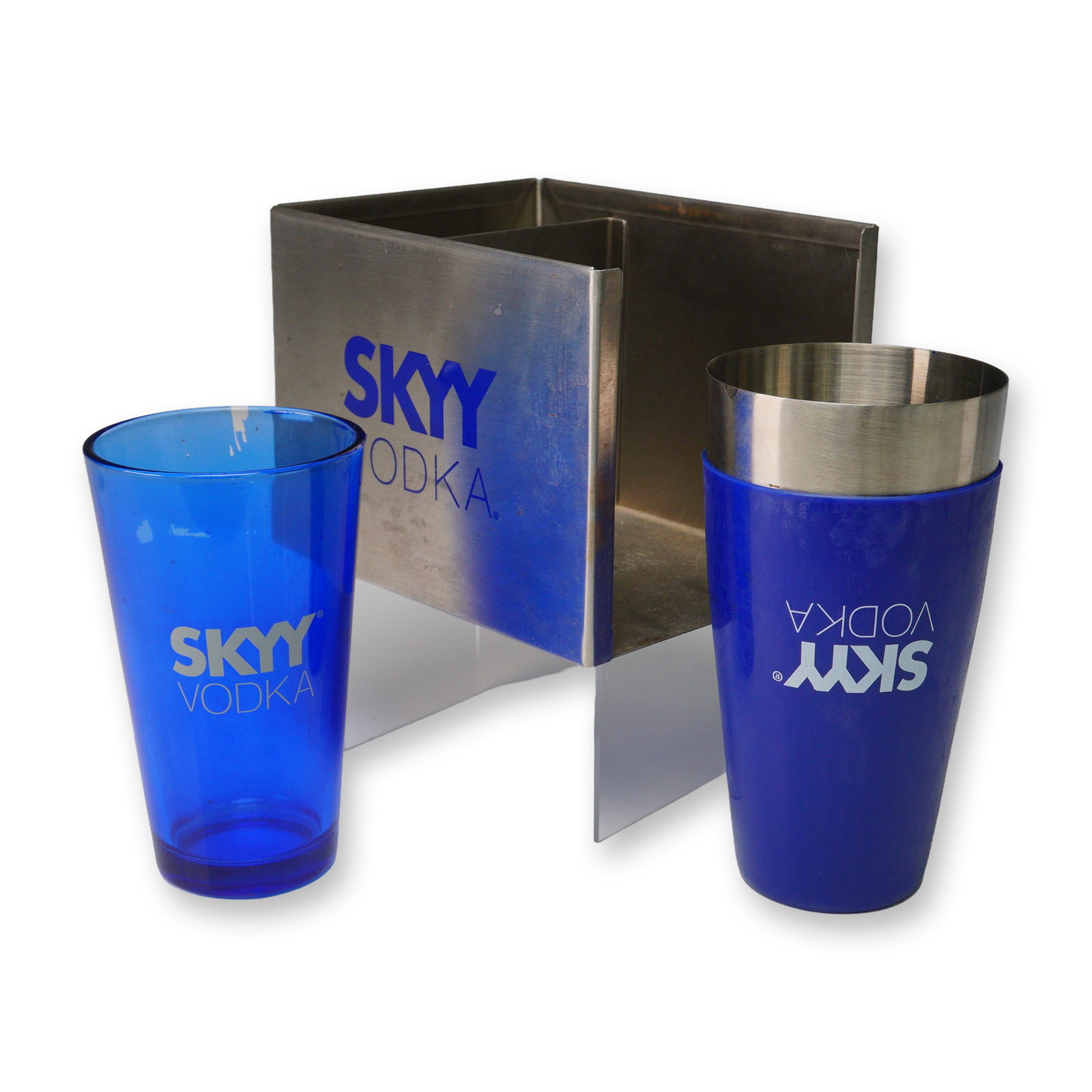 3pc Skyy Vodka Promotional Stainless Steel Bar Set: A promotional 3 piece barware set including a cobalt blue mixing glass, a coordinating shaker tin, and a brushed metal bar caddy, each prominently branded with the iconic SKYY Vodka logo in white or