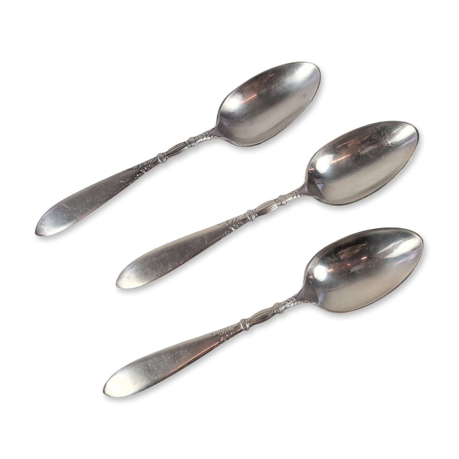 3pc 1847 Rogers Bros. Queen Ann Silver-plated Spoons: Also known as St. Moritz and introduced around 1910, each piece showcases a tapered handle with a beautifully decorative ribbed bolster, adorned with elegant scrollwork and beaded bands. The reverse