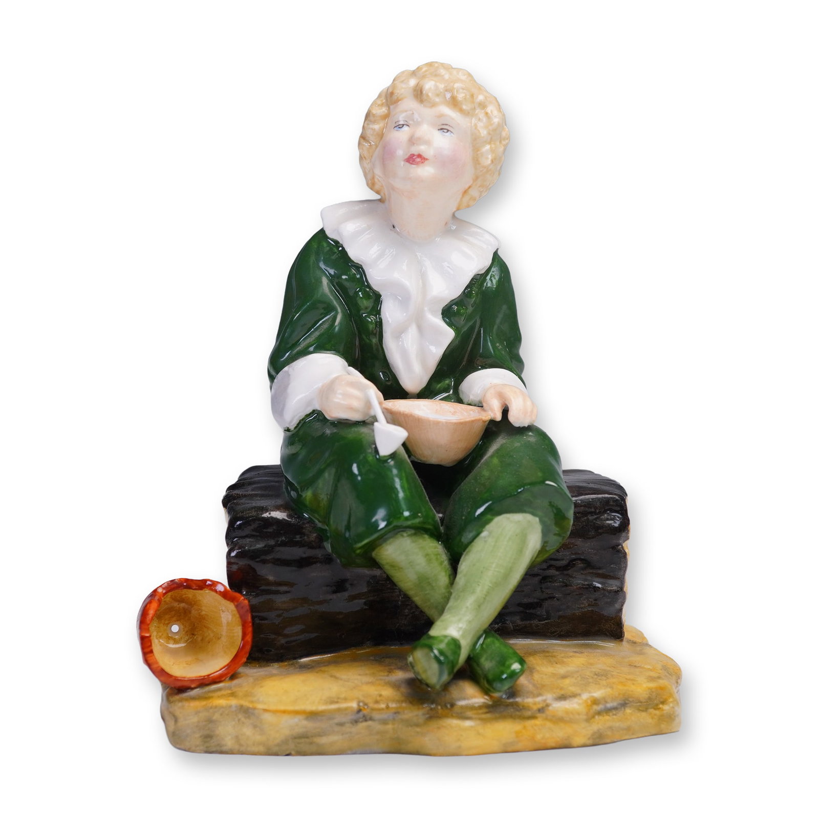 Reg Johnson and Sons Bone China Figurine, Bubbles: This hand painted bone china figurine titled Bubbles was produced by Reg Johnson and Sons in England. Depicting a curly-haired child in a green outfit with ruffled white collar, the figure is shown