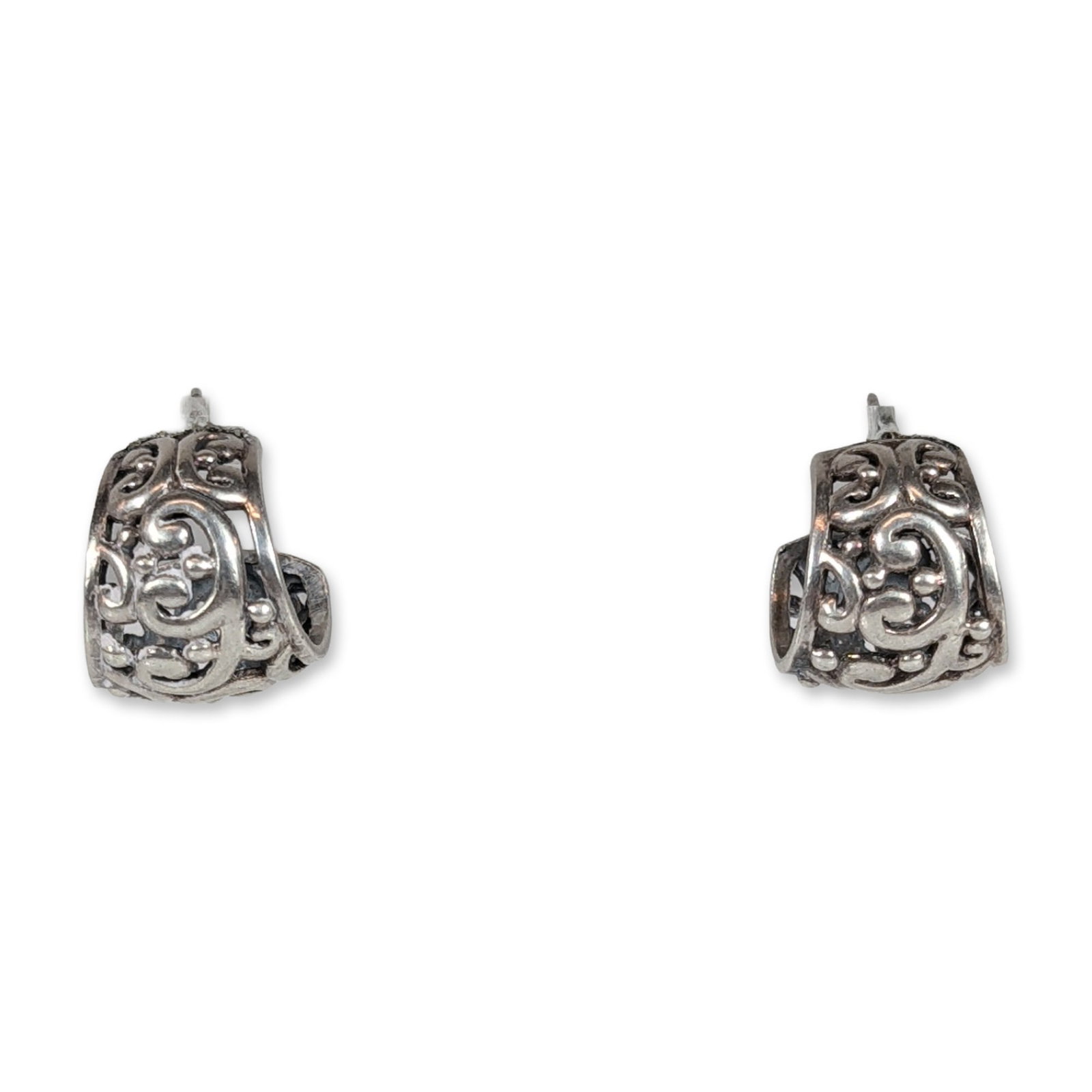 Pair of Sterling Silver Filigree J-Hoop Earrings: Pair of sterling silver earrings in a J-hoop silhouette, featuring cast openwork filigree and scrollwork decoration with spherical accents. The design incorporates recessed oxidized areas to provide v