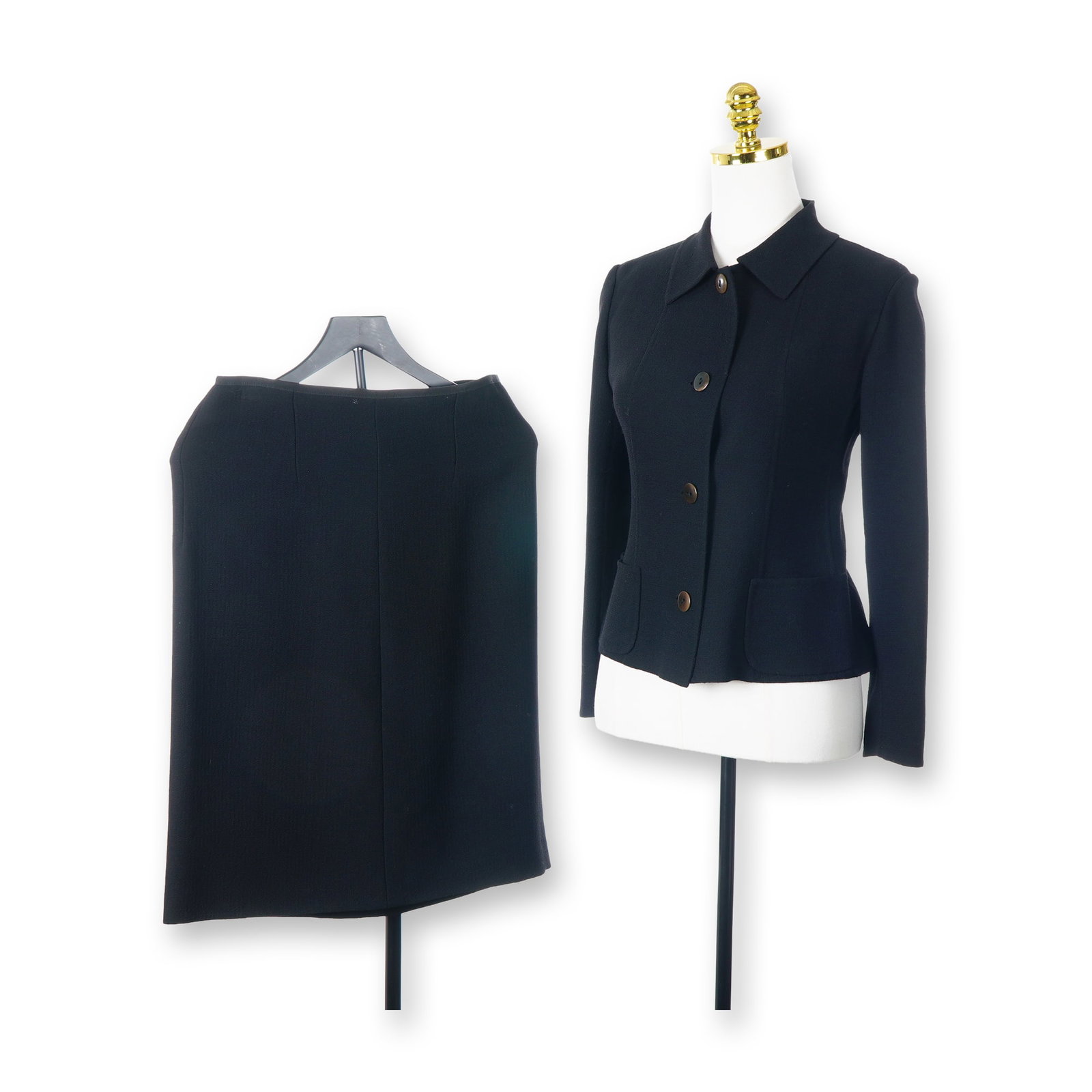 Oggi Miami Beach Black Wool Skirt Suit: This two-piece skirt suit is produced by Oggi Miami Beach and was made in Italy. The set is constructed from a black wool fabric featuring a distinct crepe-textured weave. The single-breasted jacket i
