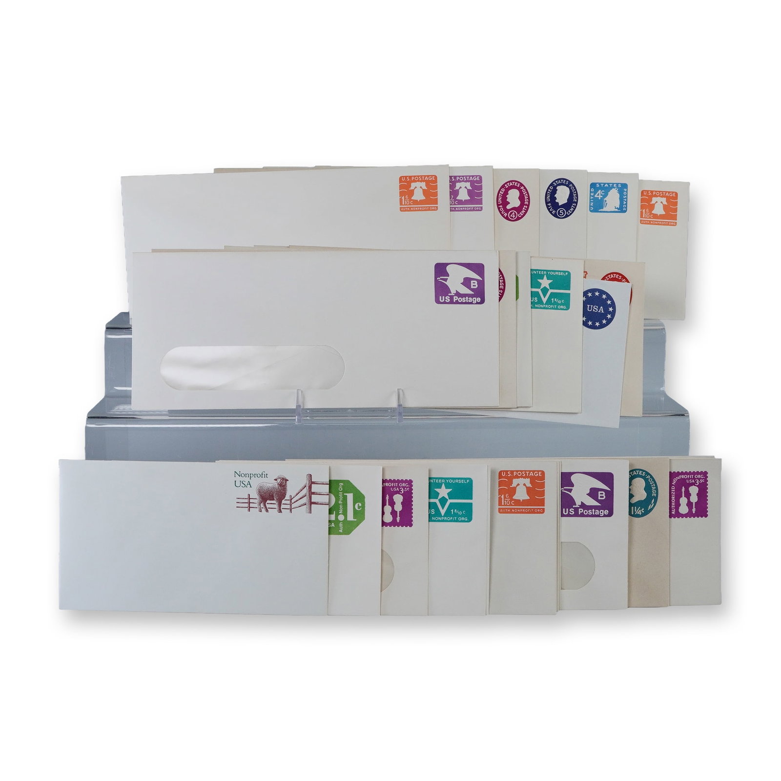 30pc Vintage US Postal Stationery Envelopes: Collection of thirty vintage United States postal stationery envelopes with pre-printed postage in assorted denominations and designs. Includes colorful examples featuring motifs such as the Liberty B