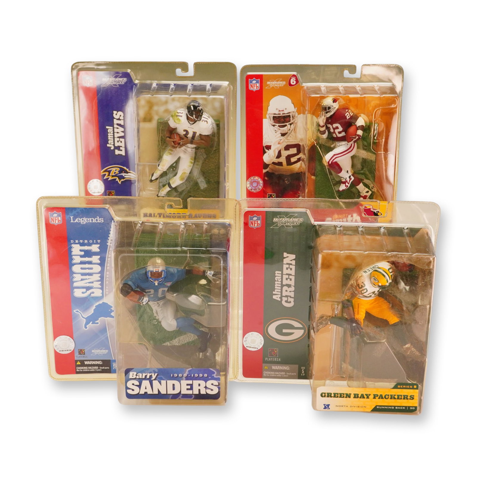 A Group of Four McFarlane Toys NFL Sportspicks Action Figures in Boxes: A collection of four action figures from the McFarlane Toys Sportspicks series featuring prominent NFL running backs. The group consists of Jamal Lewis (Baltimore Ravens, Series 8), Emmitt Smith (Ariz