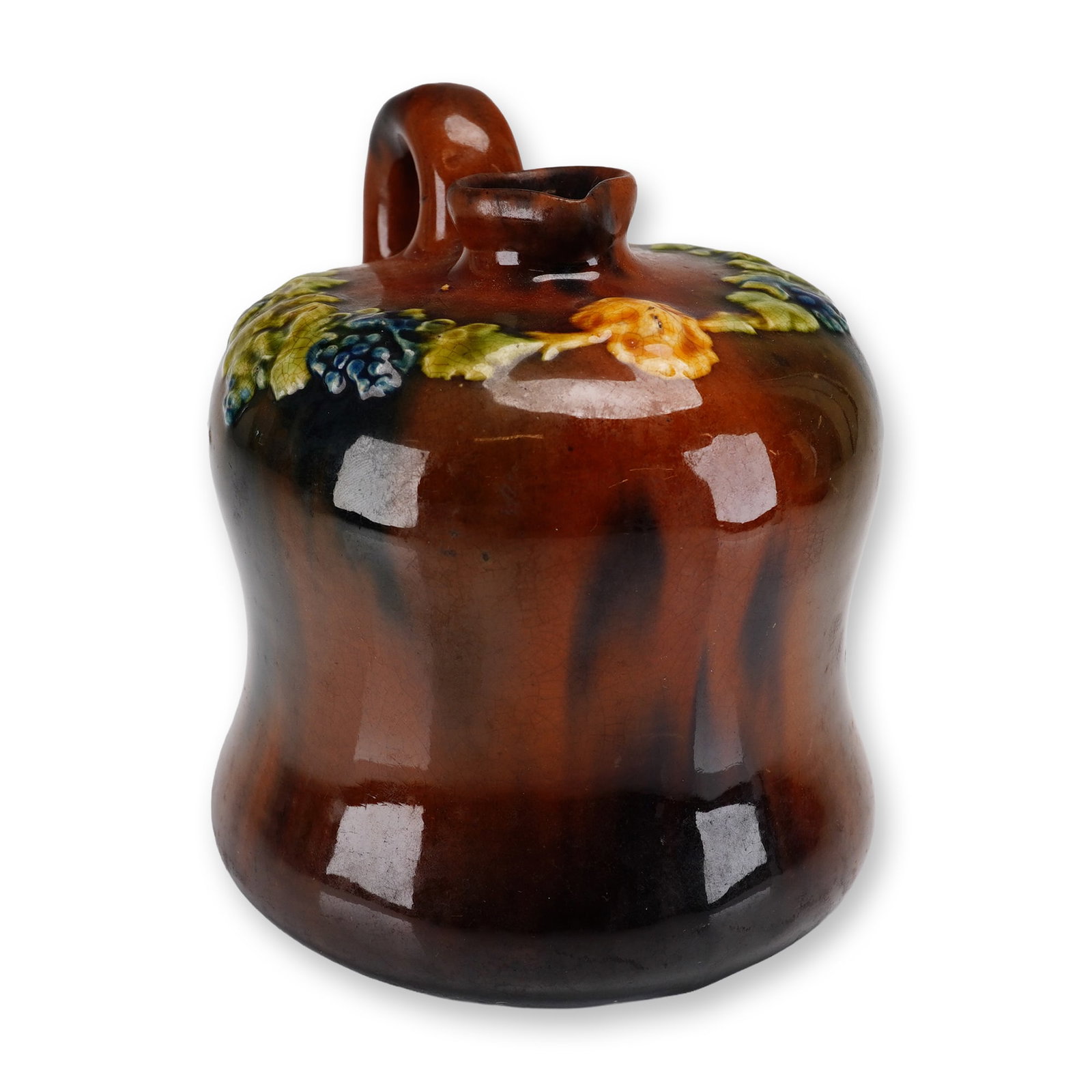 Peters and Reed Pottery Standard Glaze Relief-Molded Grape Jug: This small earthenware jug was produced by Peters and Reed Pottery of Zanesville, Ohio, during the early 20th century. The vessel features a squat, bulbous body with a slightly flared base, a short ne