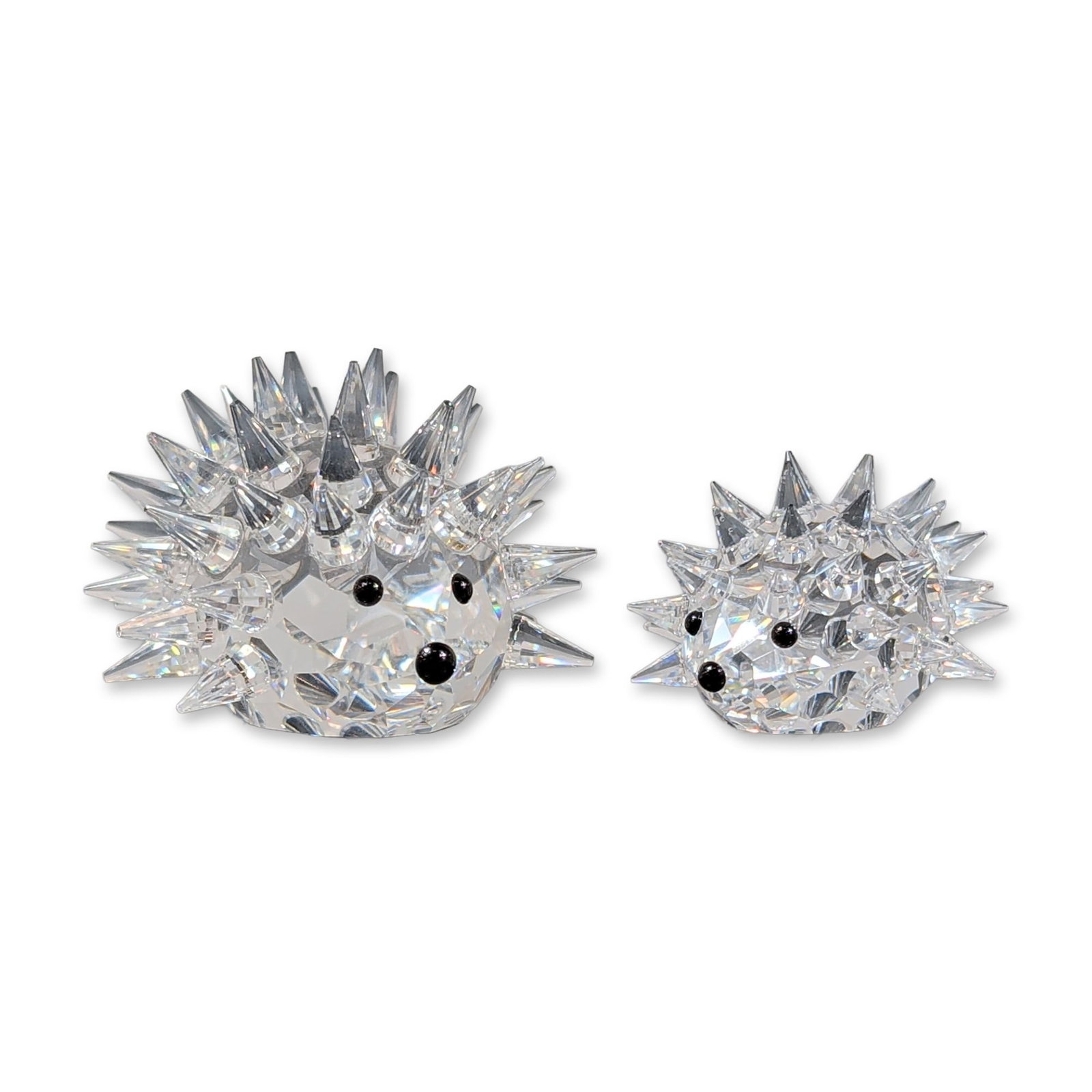 2pc Swarovski Silver Crystal Hedgehog Figurines: Swarovski. Pair of hedgehog figurines in faceted lead crystal from the Silver Crystal collection. Each figure is detailed with numerous pointed crystal quills and inset black crystal beads representin