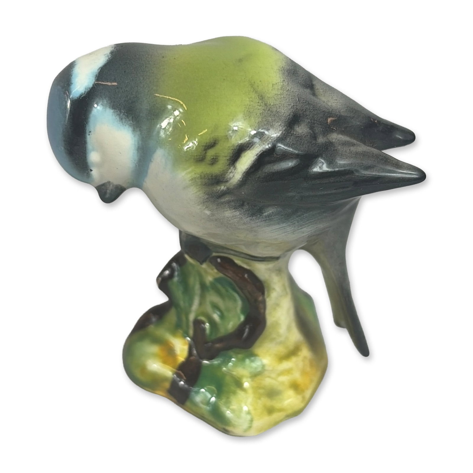 Beswick Porcelain Blue Tit Figurine: Figurine of a Blue Tit (Cyanistes caeruleus) perched on a foliate-molded base. The bird is rendered with a blue cap, white facial patches, yellow-green back, and grey wings and tail. The underside