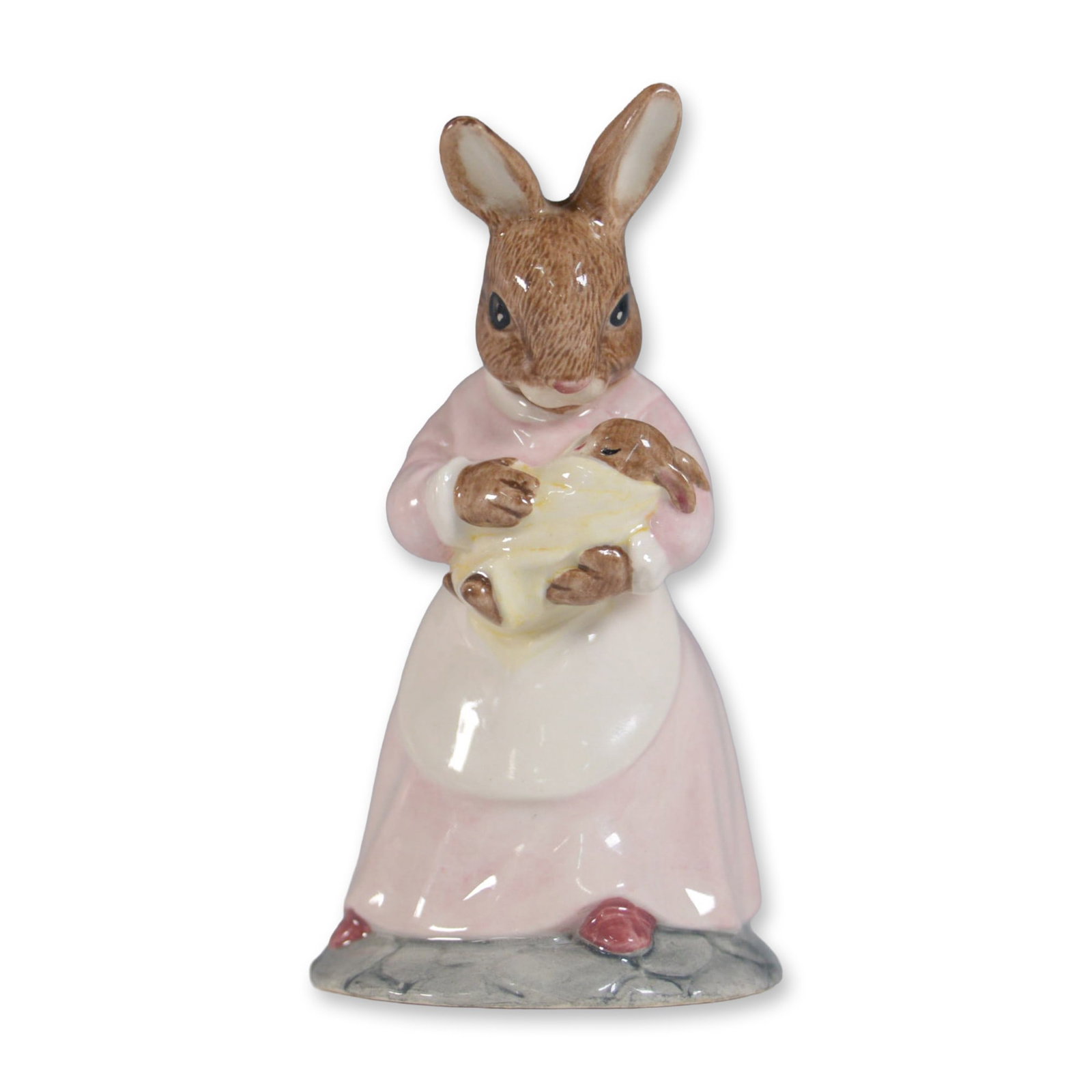 Royal Doulton Bunnykins Figurine, Mother and Baby DB167: Charming Royal Doulton Bunnykins figurine titled Mother and Baby, model DB167, issued in 1989. This delightful piece features a mother bunny dressed in a pink gown with an apron, tenderly holding her 