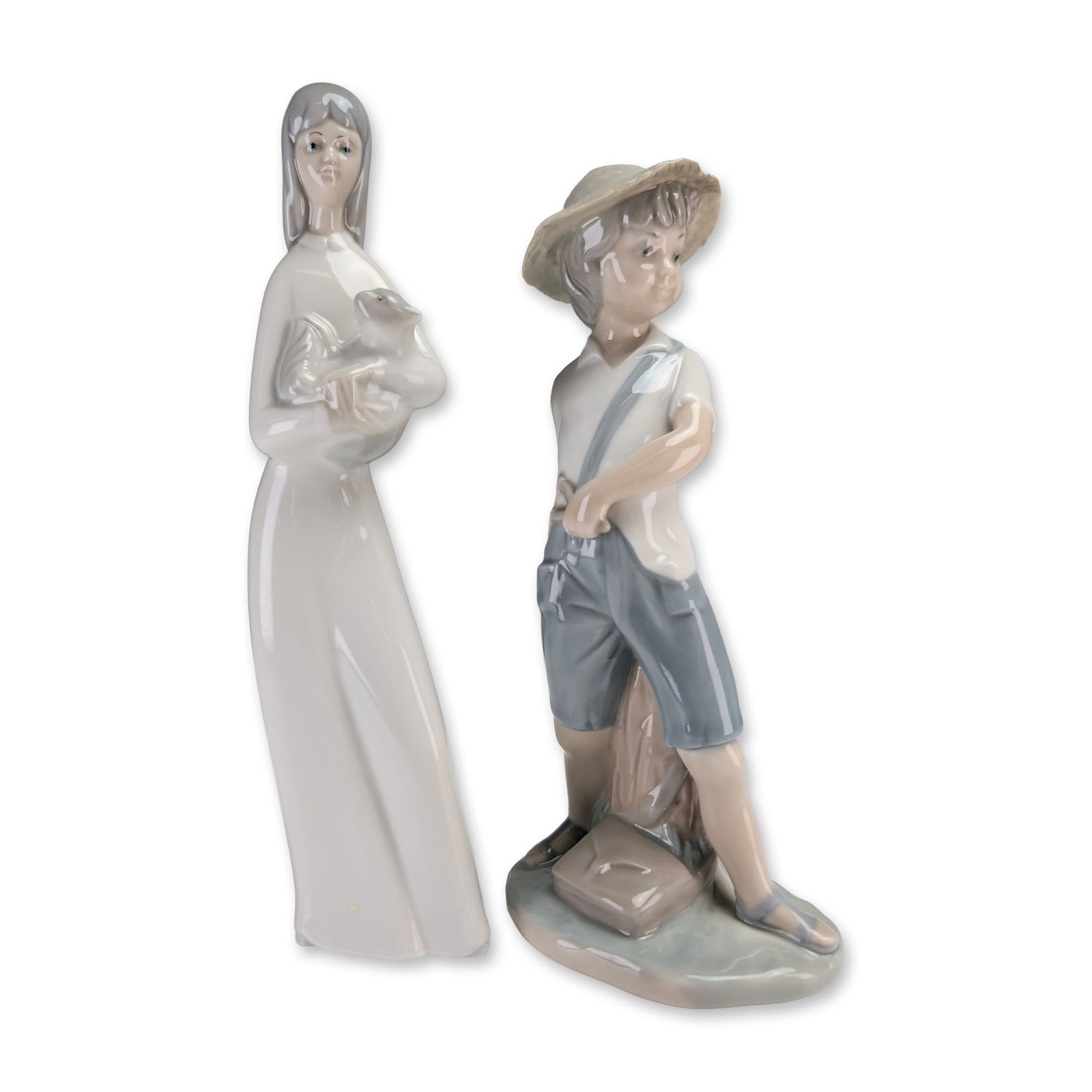 2pc Porceval & Nao by Lladro Porcelain Figurines: Pair of Spanish glazed porcelain figurines featuring youthful subjects. The first figurine, produced by Nao, depicts a young boy in a wide-brimmed straw hat, white short-sleeved shirt with blue