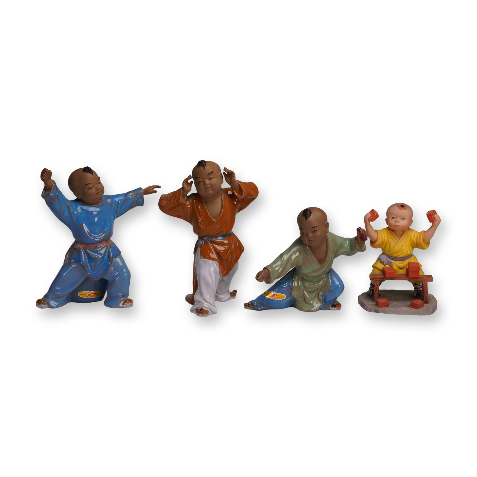4pc Chinese Porcelain Children Figurines: A lively 4-piece group of Chinese porcelain figurines depicting young boys in dynamic poses. Each figure is hand-painted in bright robes of blue, orange, green, and yellow, with expressive facial