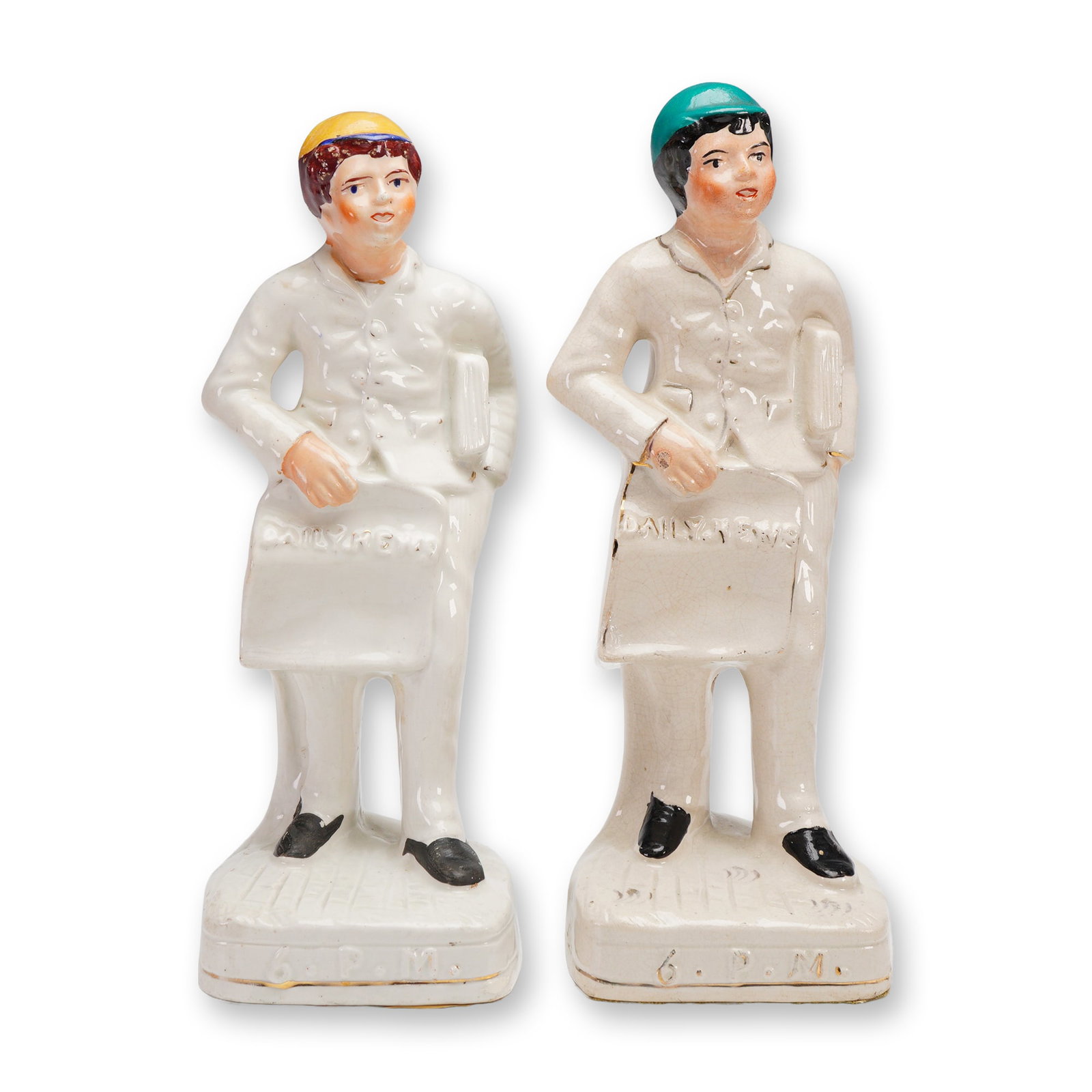2pc Antique Staffordshire Sculptures , Daily News 6PM: Victorian-era Staffordshire porcelain figurines depicting young newspaper delivery boys, each holding a "Daily News" bag marked 6 P.M. at the base. These figures, commonly attributed to Staffordshire 