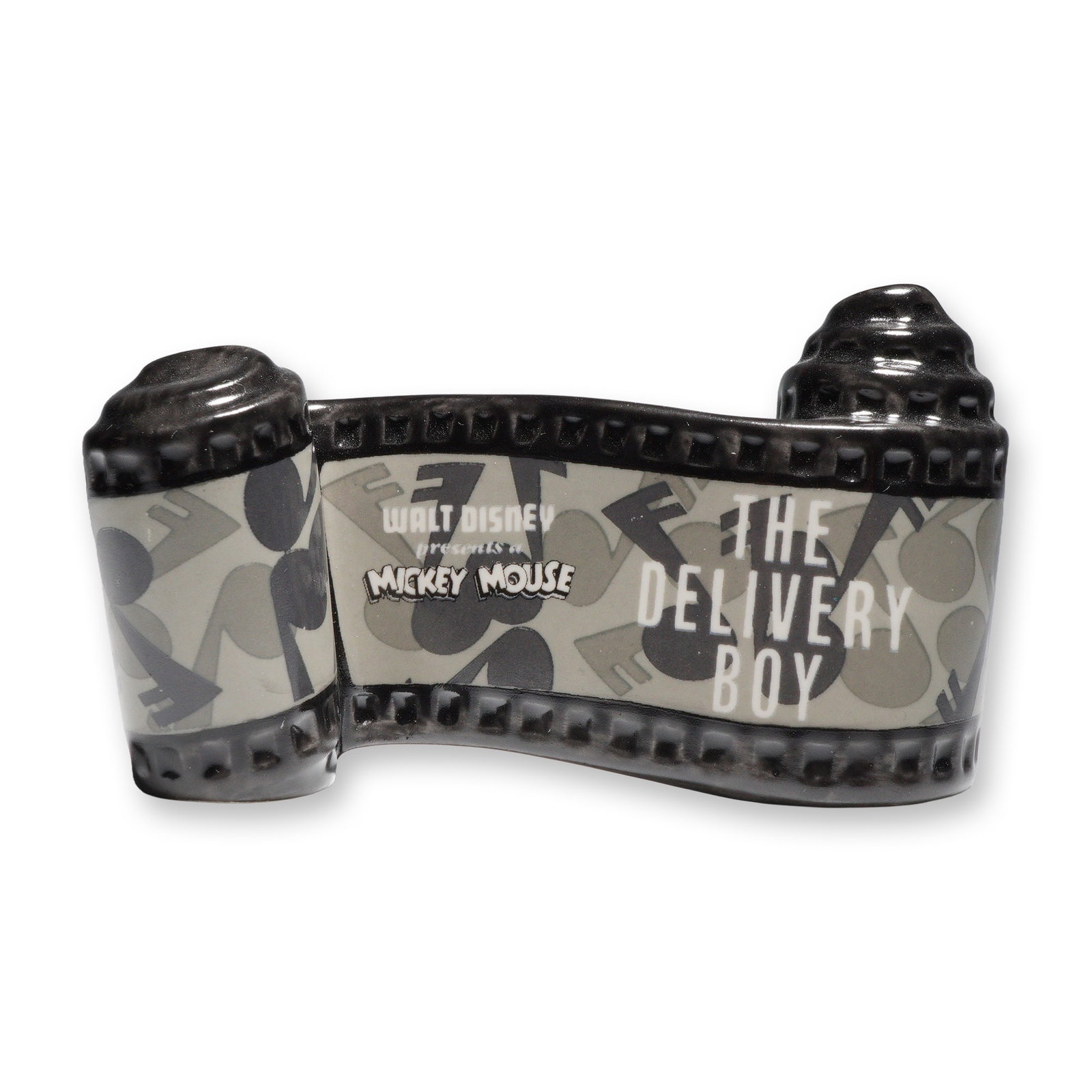 Walt Disney Classics, The Delivery Boy Opening Title: Walt Disney Classics Collection ceramic title from Mickey Mouse's 1931 short film The Delivery Boy. The sculpted filmstrip design reads Walt Disney presents Mickey Mouse The Delivery Boy in raised
