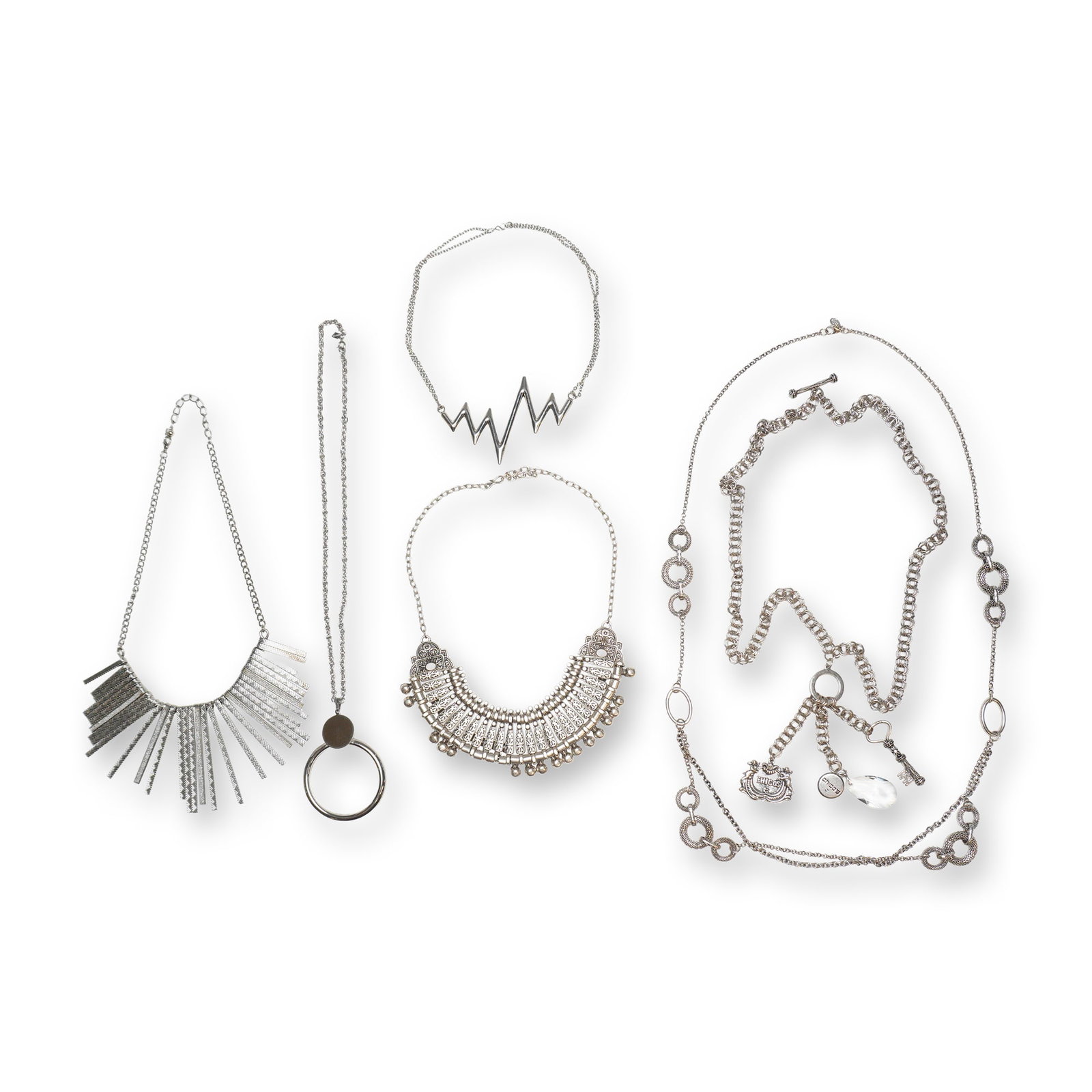 A 6pc Collection of Silver-Tone Statement and Fashion Necklaces Including Chico's and Sarah Coventry: This six-piece lot of silver-tone costume jewelry features an assortment of contemporary and vintage-style necklaces. The collection includes a fringe statement collar necklace crafted with textured r
