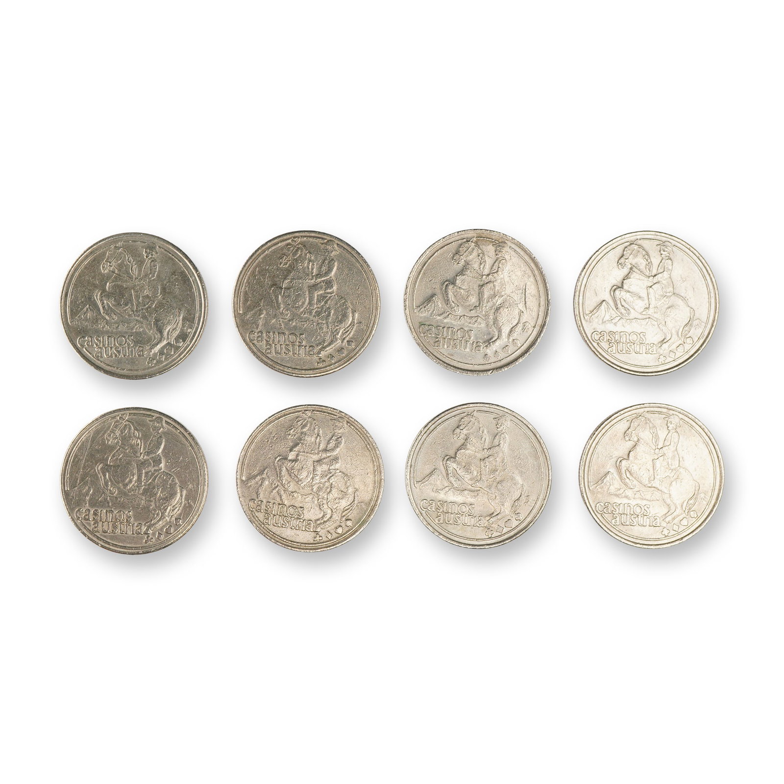 10pc Austin Casino Gambling Tokens: Group of 1.5" silver toned gaming tokens. The obverse depicts man on horse with Casinos Austin lettering below. The reverse depicts a bird in flight with Ride a Lucky Wave lettering below. Dimensions:
