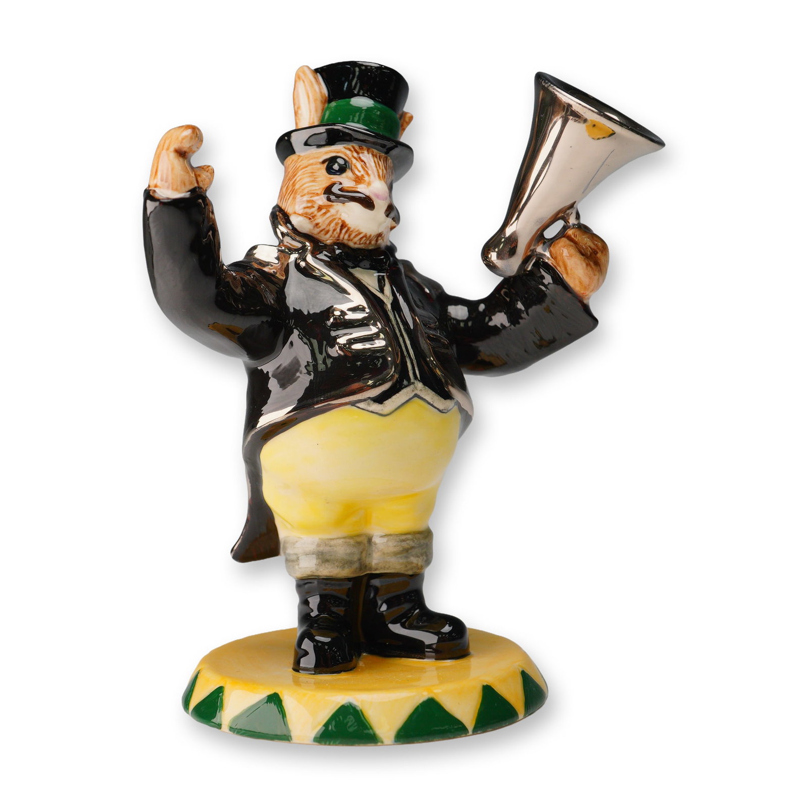 Royal Doulton Bunnykins Prototype Figurine, Randolf the Ringmaster: This hand-painted ceramic figurine portrays a standing anthropomorphic rabbit wearing a black tailcoat with silver-metallic accents, yellow trousers, and a top hat with a green band. One arm is raised