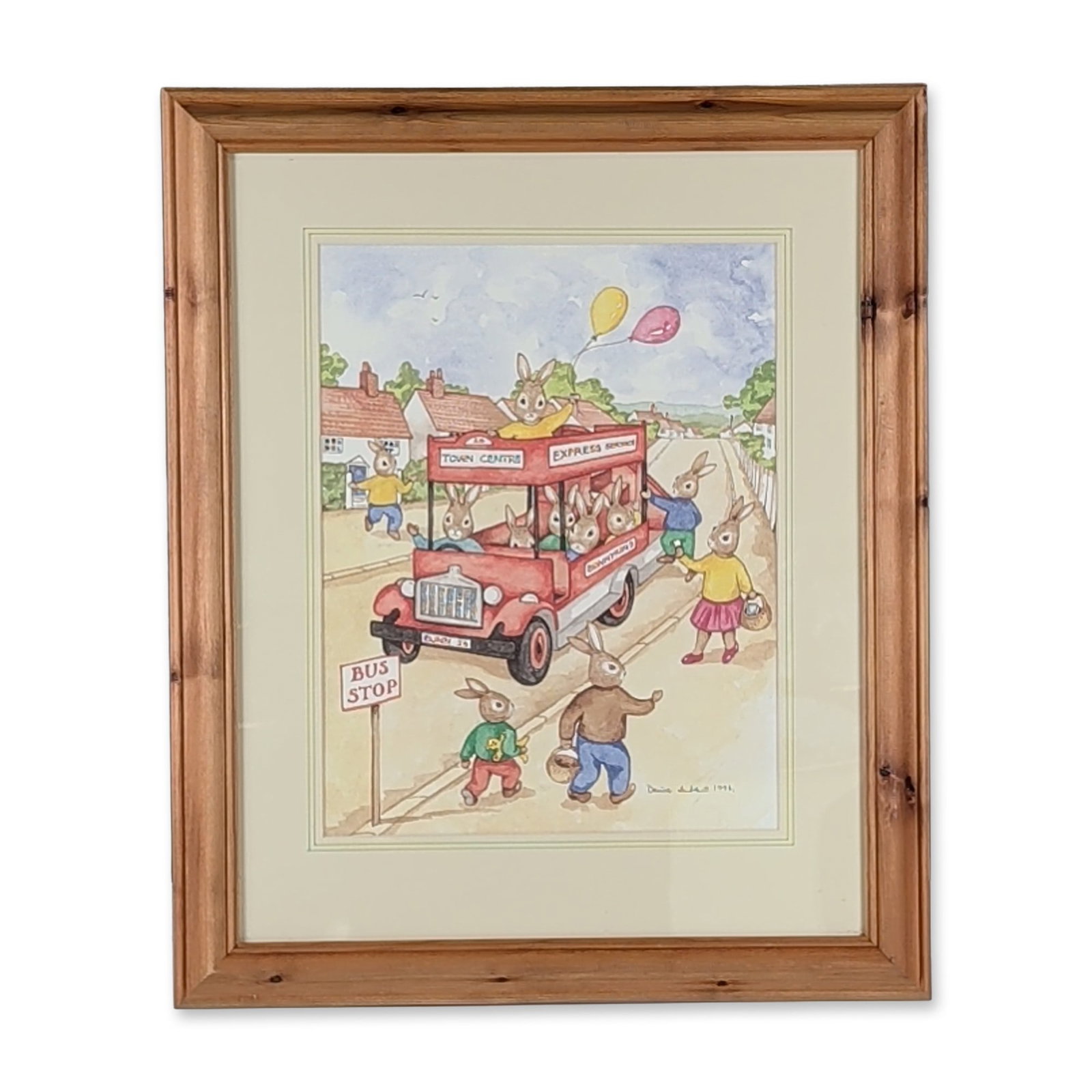Denise Andrews 1994 Framed Original Watercolor Bunnykins Painting, The Bus Stop: Housed in a wooden frame with a cream-colored mat, an original watercolor on paper featuring Bunnykins. The whimsical scene depicts a red double-decker bus with signage for Town Centre, Express Servic