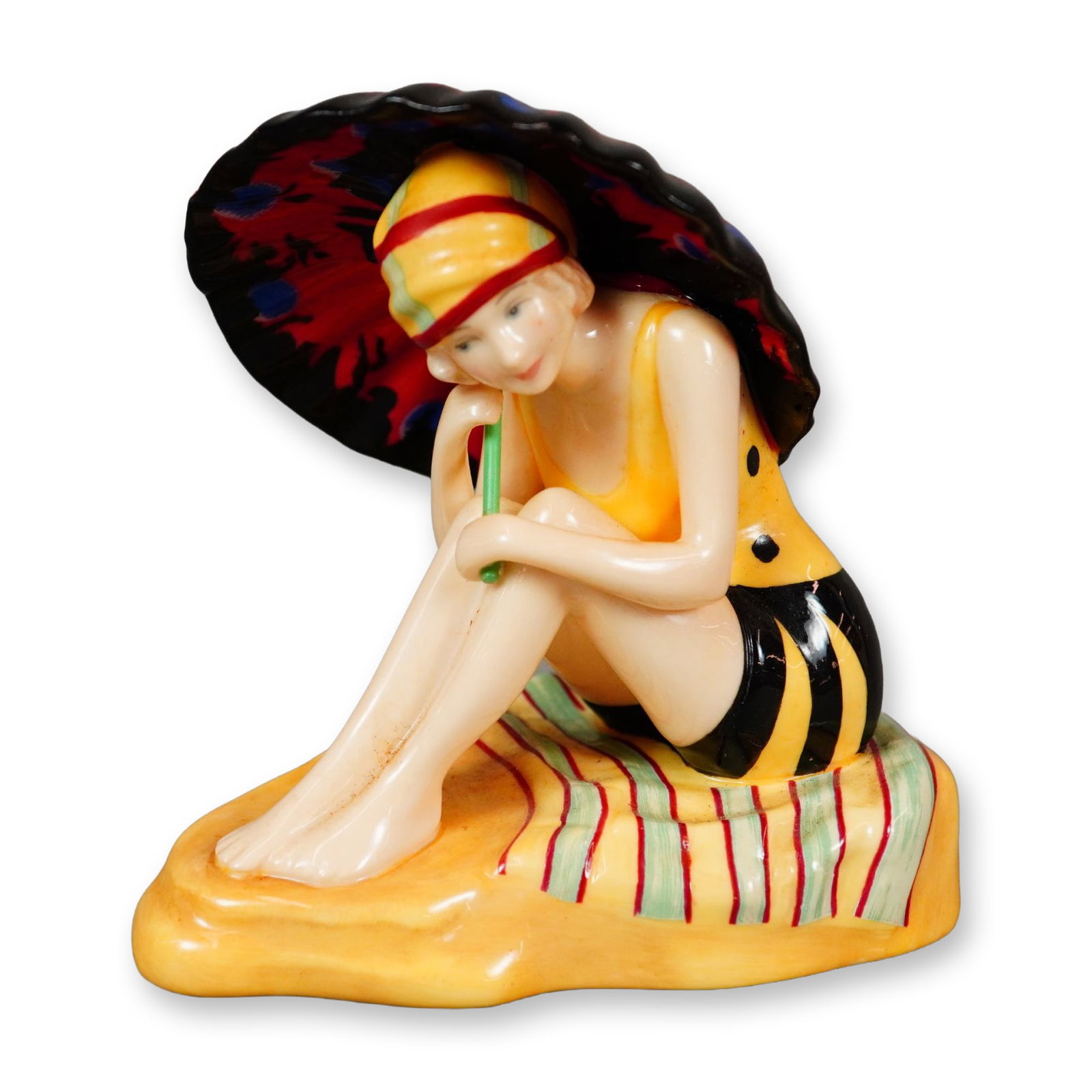 Royal Doulton HN Icons Bone China Figurine, Sunshine Girl HN5650: Hand painted figure of an Art Deco woman on the beach. She is shown in a yellow and black swimsuit. She is holding a colorful umbrella. Royal Doulton backstamp. Dimensions: 3.25"L x 3.25"W x 3"H Editi
