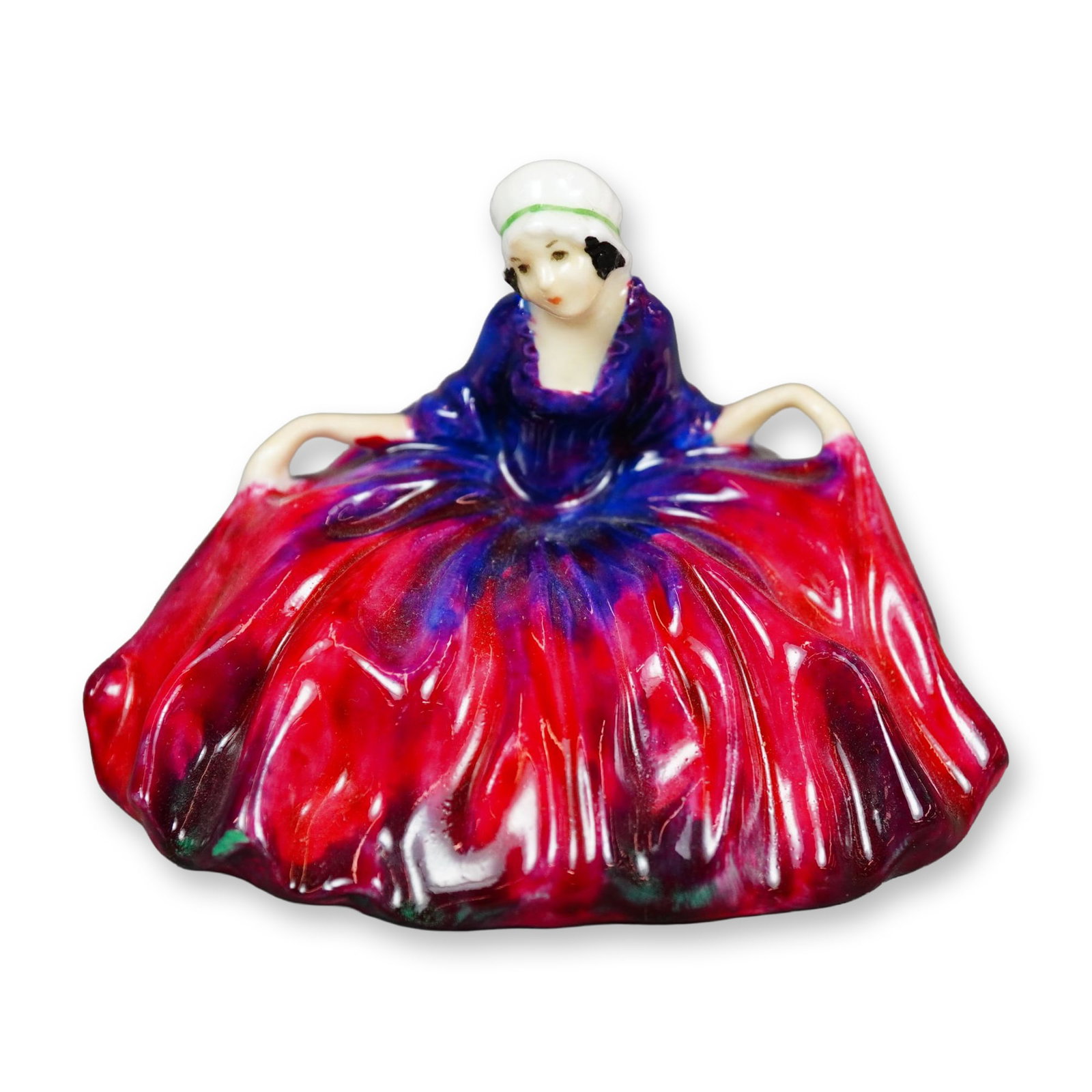Royal Doulton Colorway Figurine, Polly Peachum: Character from "The Beggar's Opera", the figure depicts a young woman curtsying. She is shown wearing pink and purple gown. Royal Doulton backstamp. Dimensions: 3"L x 2.5"W x 2.25"H Manufacturer or Br