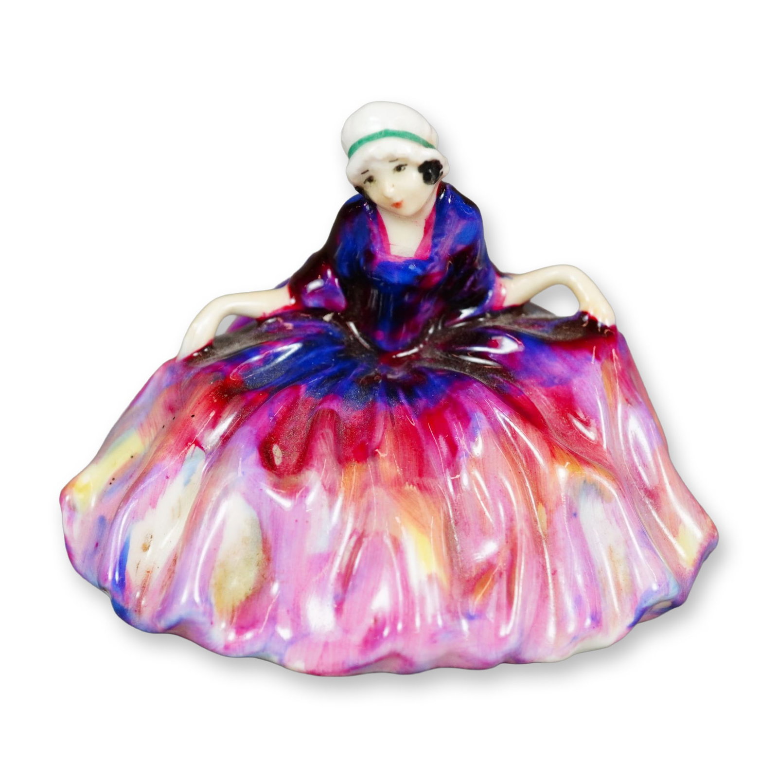 Royal Doulton Figurine, Polly Peachum: Character from "The Beggar's Opera", the figure depicts a young woman curtsying. She is shown wearing a pink and purple gown with yellow accents. Royal Doulton backstamp. Dimensions: 3"L x 2.5"W x 2.2