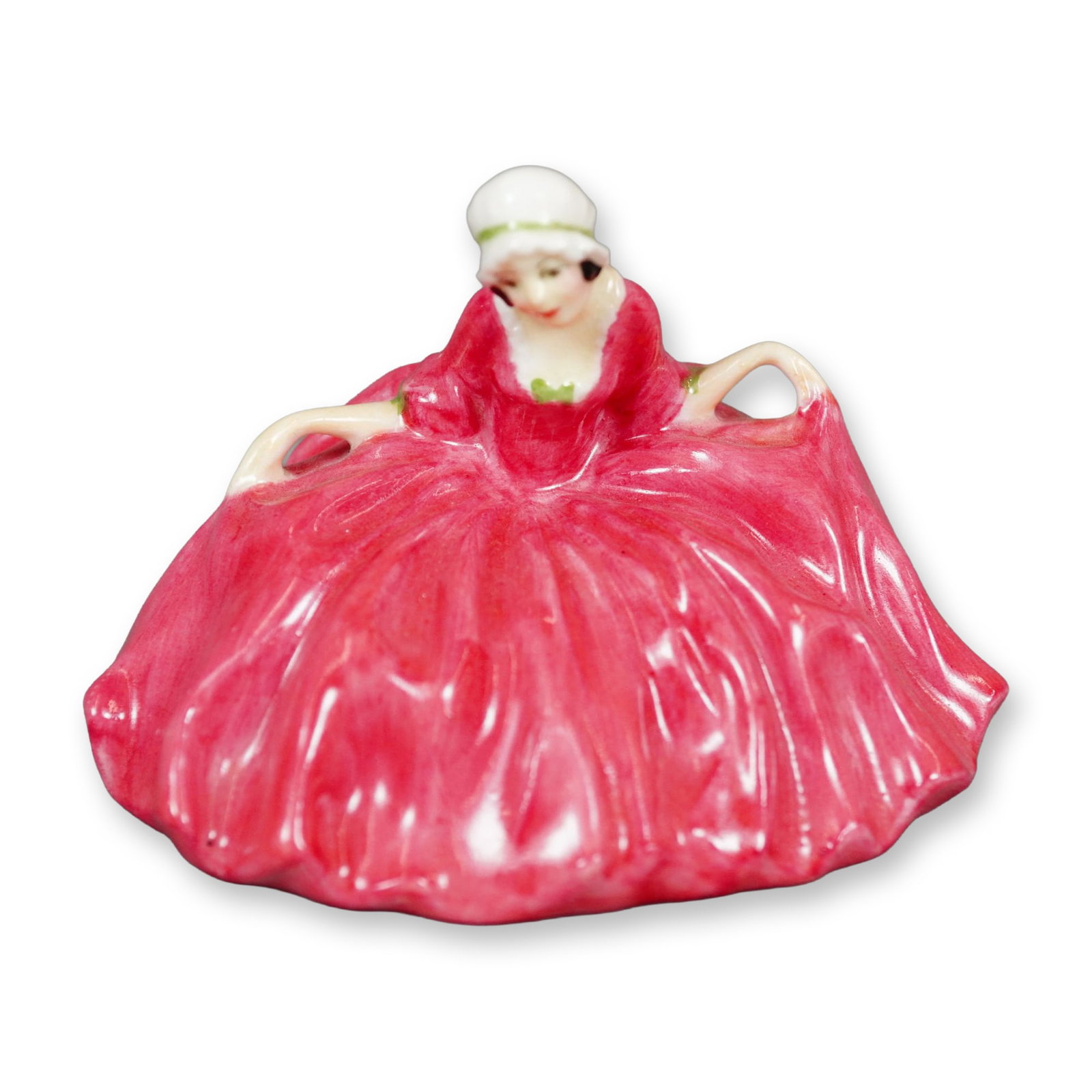 Royal Doulton Figurine, Polly Peachum M21: Character from "The Beggar's Opera", the figure depicts a young woman curtsying. She is shown wearing dark pink dress with green accents. Royal Doulton backstamp. Dimensions: 3"L x 2.5"W x 2.25"H Manu