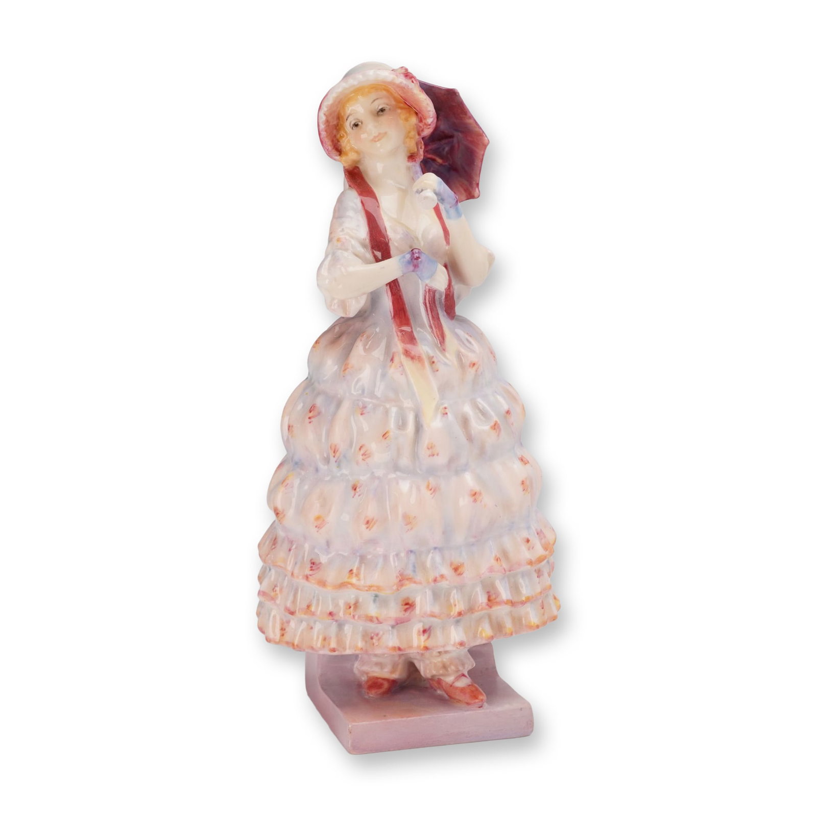 Royal Doulton Porcelain Figurine, Helen HN1509: Designed by Leslie Harradine. The figure depicts a young woman in a tiered, ruffled crinoline gown decorated with painted floral details, wearing a wide bonnet with a prominent red ribbon, and holding