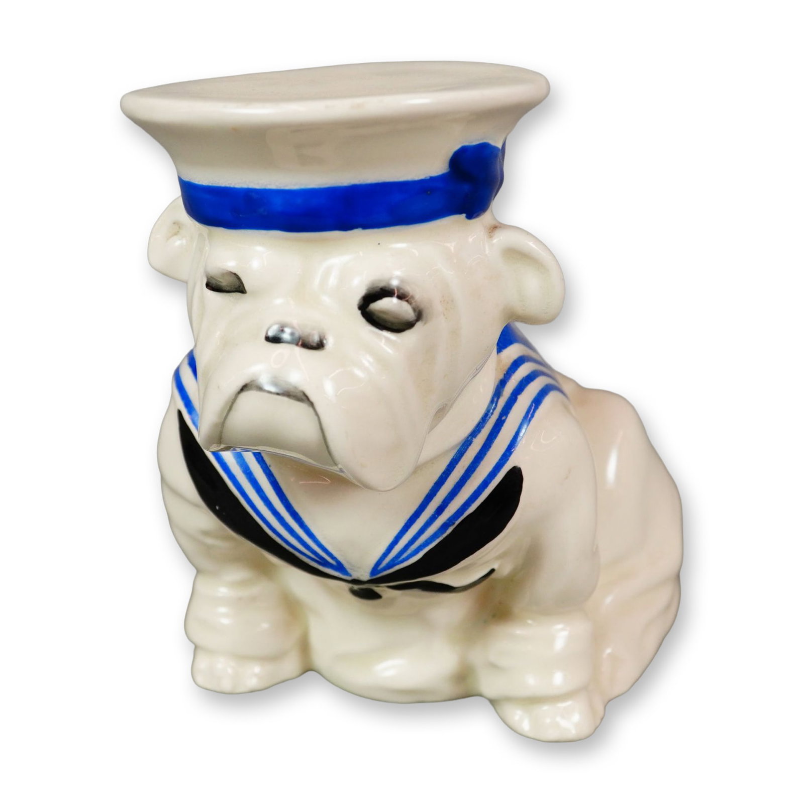 Royal Doulton Porcelain Medium Figurine, Bulldog Wearing Sailor Suit and Hat D6193: Hand painted figure of a seated cream-colored bulldog wearing a navy and white sailor's suit and hat. Royal Doulton backstamp. Dimensions: 5.75"L x 3.5"W x 4.75"H Date or Era: c. 1941 Manufacturer or 