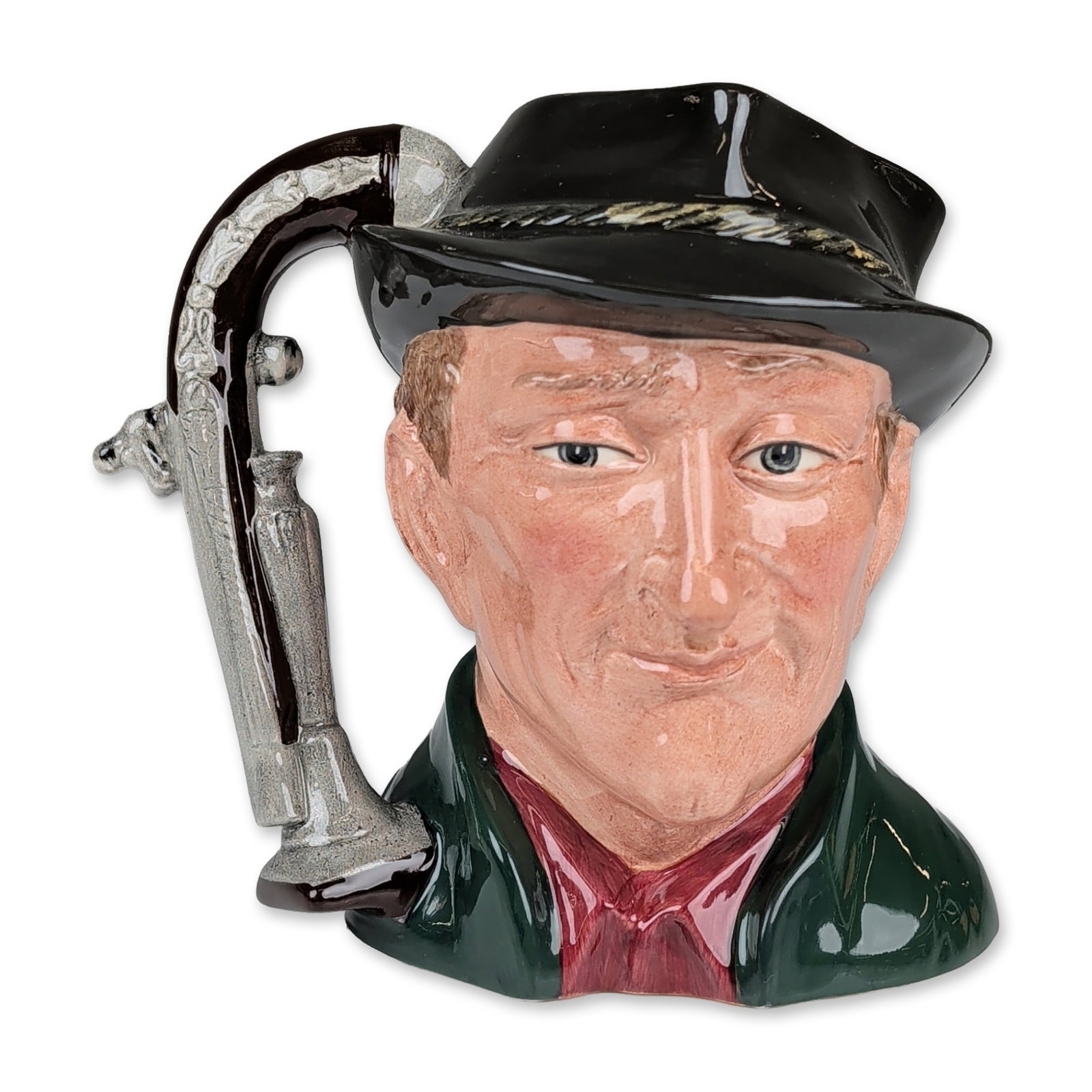 Royal Doulton Prototype Large Character Jug, The Antique Dealer D6807: Hand-decorated ceramic figure depicting a male dealer wearing a black tricorn hat with gold and silver braided band, dark green frock coat, and red waistcoat. The handle is modeled in the form of a si