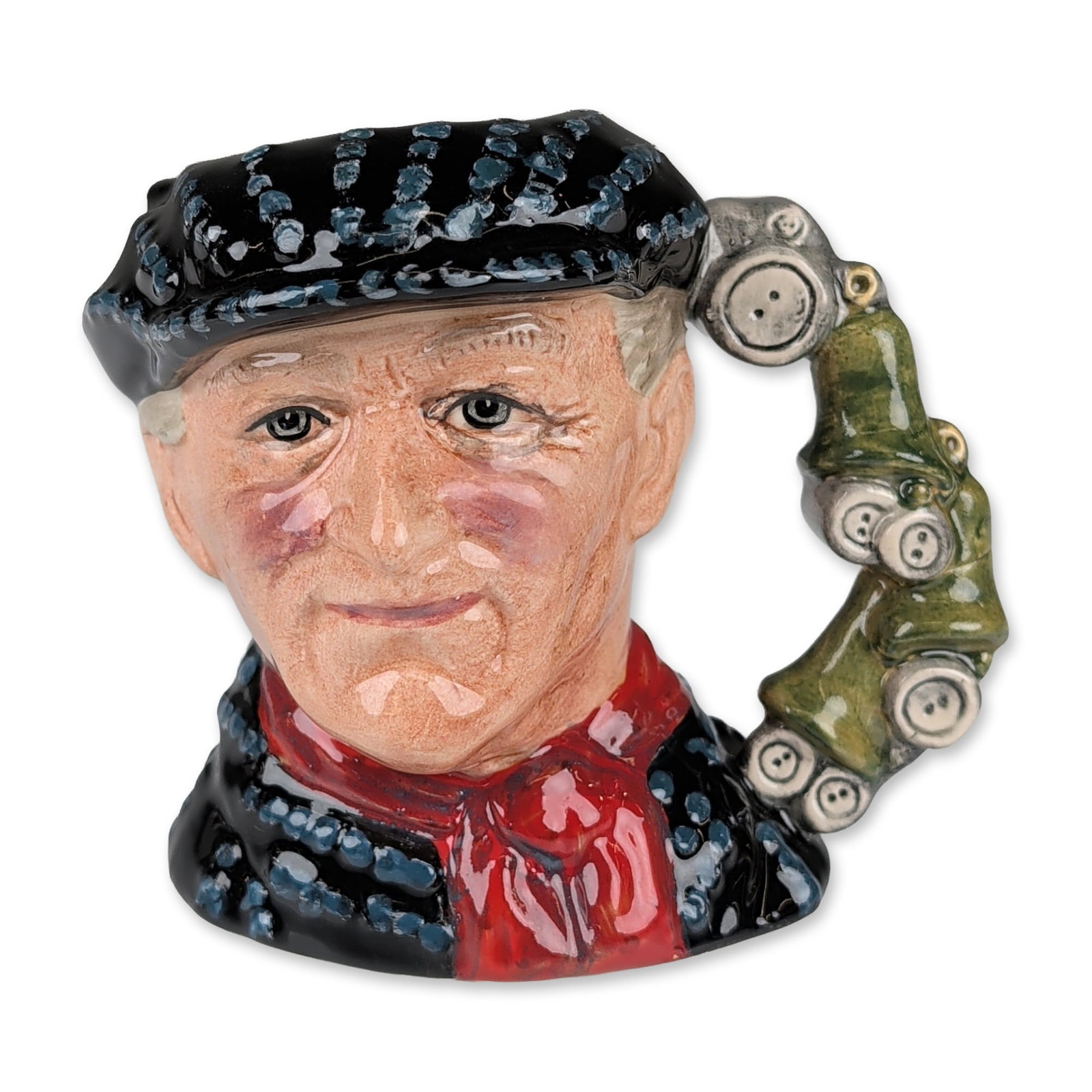 Royal Doulton Prototype Colorway Small Character Jug, Pearly King D6844: Depicts a man in traditional London Pearly King attire, featuring a black cap and jacket heavily accented with light blue and white pearl button motifs. He wears a vibrant red cravat similarly decorat
