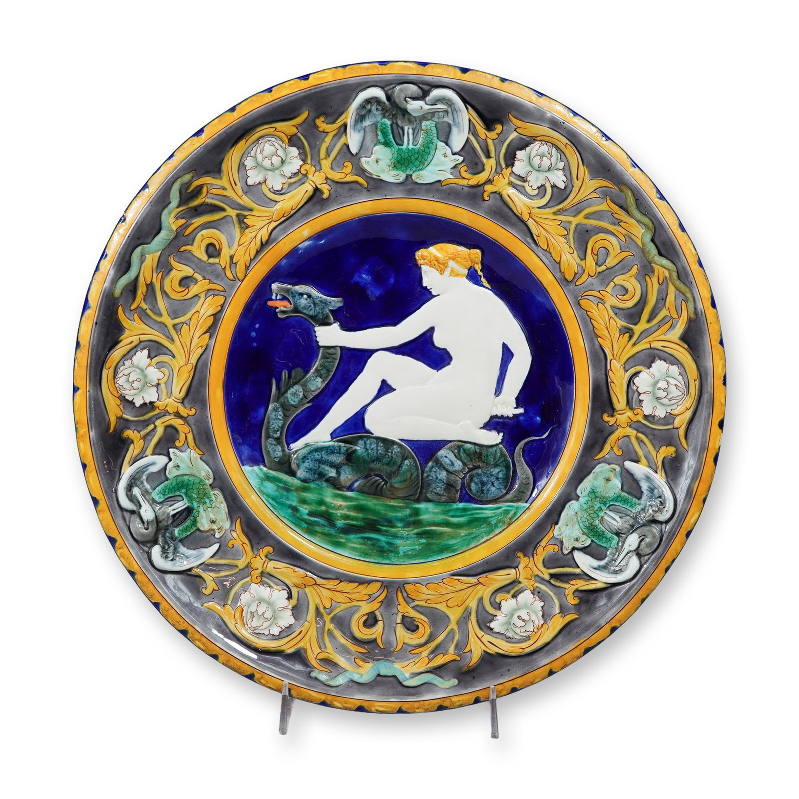 Wedgwood Majolica Classical Scene Sea Monster Charger: A large Victorian Wedgwood majolica platter featuring a central relief-molded medallion of a classical female figure riding a sea serpent. The central figure is finished in a white glaze against a dee