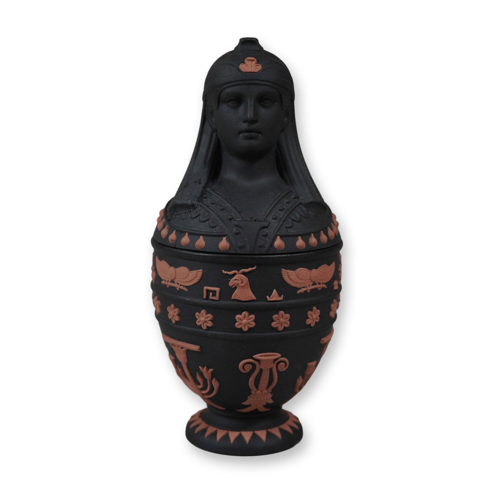 Wedgwood Egyptian Revival Black Basalt and Rosso Antico Canopic Jar: This lidded stoneware vessel is designed in the Egyptian Revival style and is part of the Wedgwood Egyptian Collection. The piece is constructed from matte black basalt stoneware featuring applied ter
