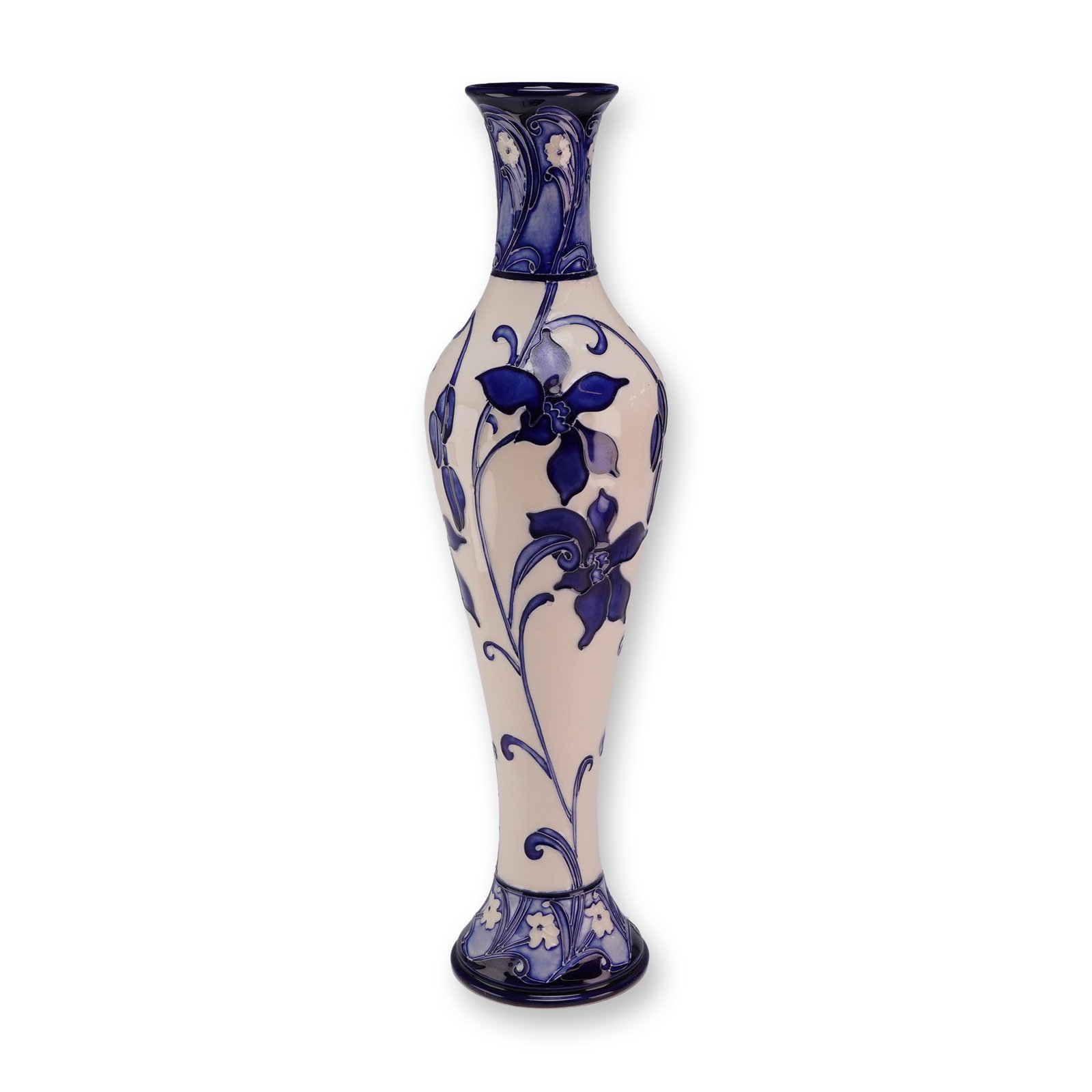 Moorcroft Pottery by Kerry Goodwin Centennial Vase, Australian Orchid: Featuring stylized floral motifs in shades of cobalt and indigo blue on a cream ground, the piece is executed using hand applied tube lining, a technique in which raised clay slip outlines are filled 