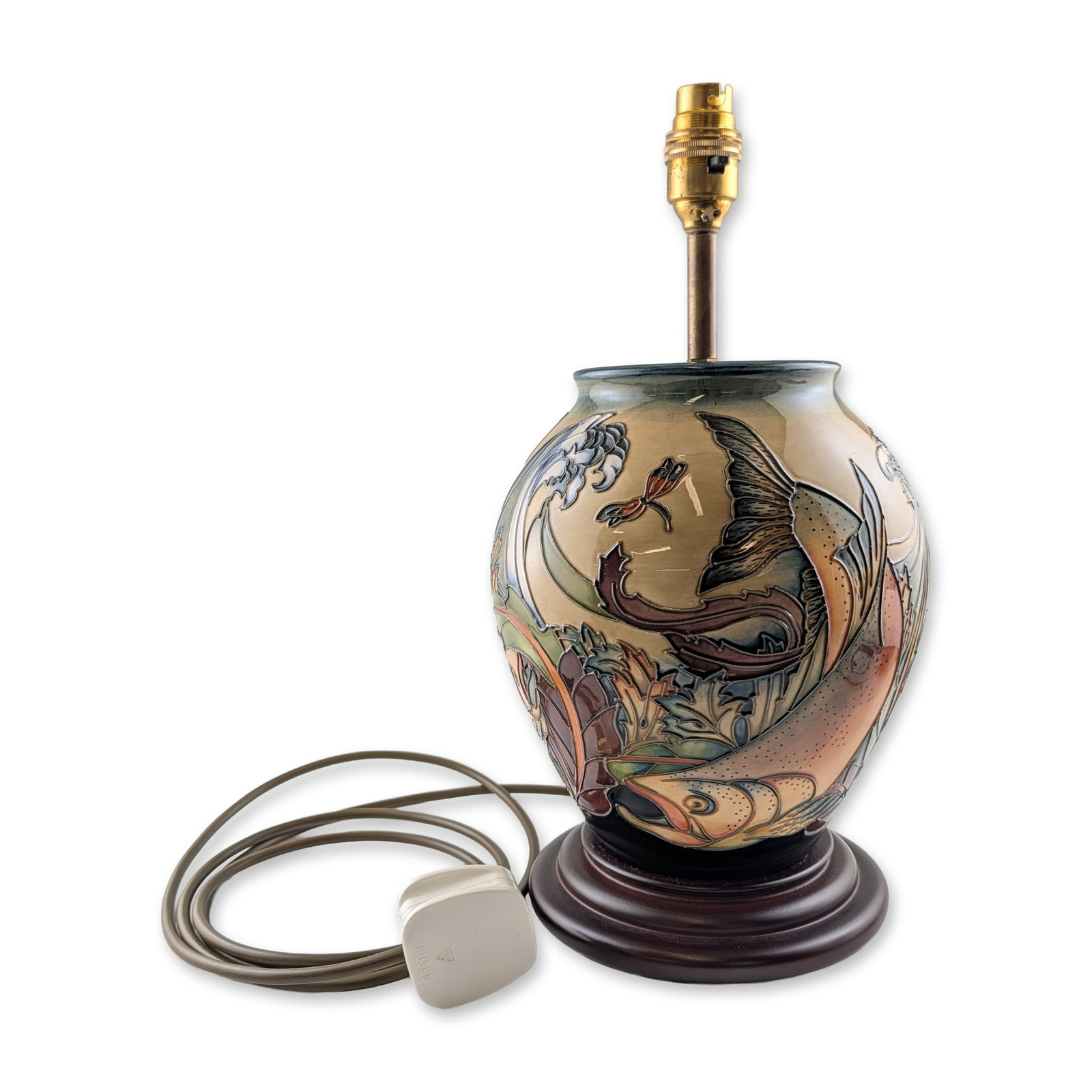 Moorcroft Pottery by Philip Gibson Table Lamp, Trout: The ovoid ceramic body is decorated using the tube-lining technique, featuring a large leaping trout among stylized aquatic foliage, reeds, waves, and a dragonfly. The design is executed in a palette 