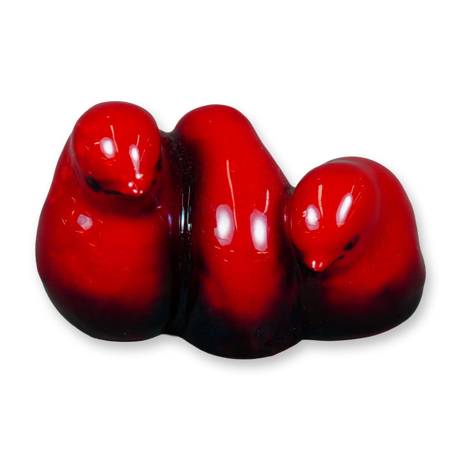Royal Doulton Flambe Porcelain Figurine, Three Chicks: A figurine of three baby birds huddled together, finished in a rich red flambe glaze. Features the Royal Doulton Flambe backstamp. Model number 1163. Artist: Charles Noke Dimensions: 3.75"L x 2.25"W x
