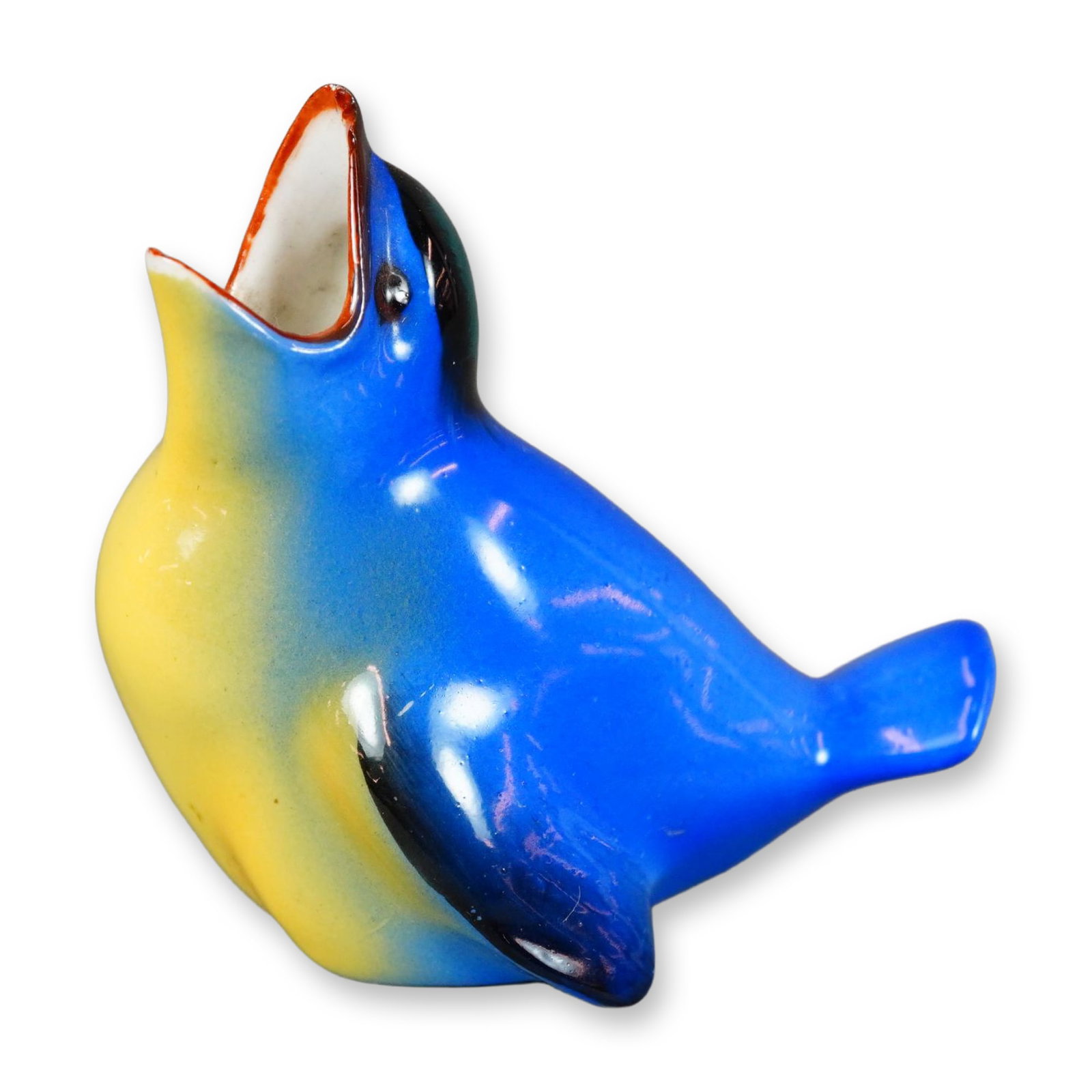 Royal Doulton Porcelain Bird Figurine, Fledgling HN137A: Hand-painted figurine of a baby bird rendered in yellow and blue tones, with a green-tinged head, black wings, and a brown beak. The bird is shown seated with its beak open wide. Royal Doulton backsta