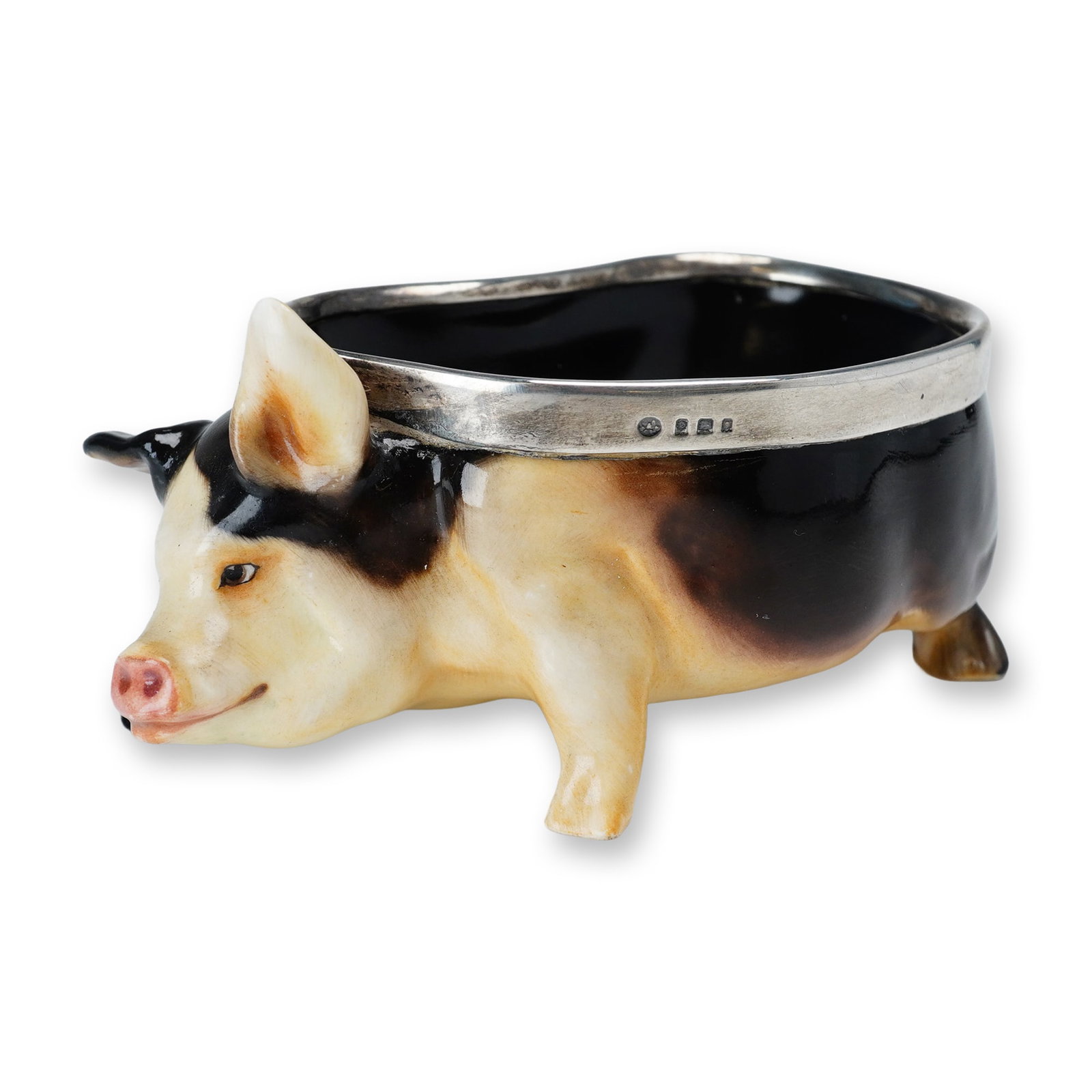 Royal Doulton Porcelain and Sterling Silver Rim Pig Bowl, HN243: A figural bowl modeled in the form of a pig, finished in brown and cream-toned hues and accented with a sterling silver-mounted rim. The rim bears the hallmark of George Betjemann & Sons, and the unde