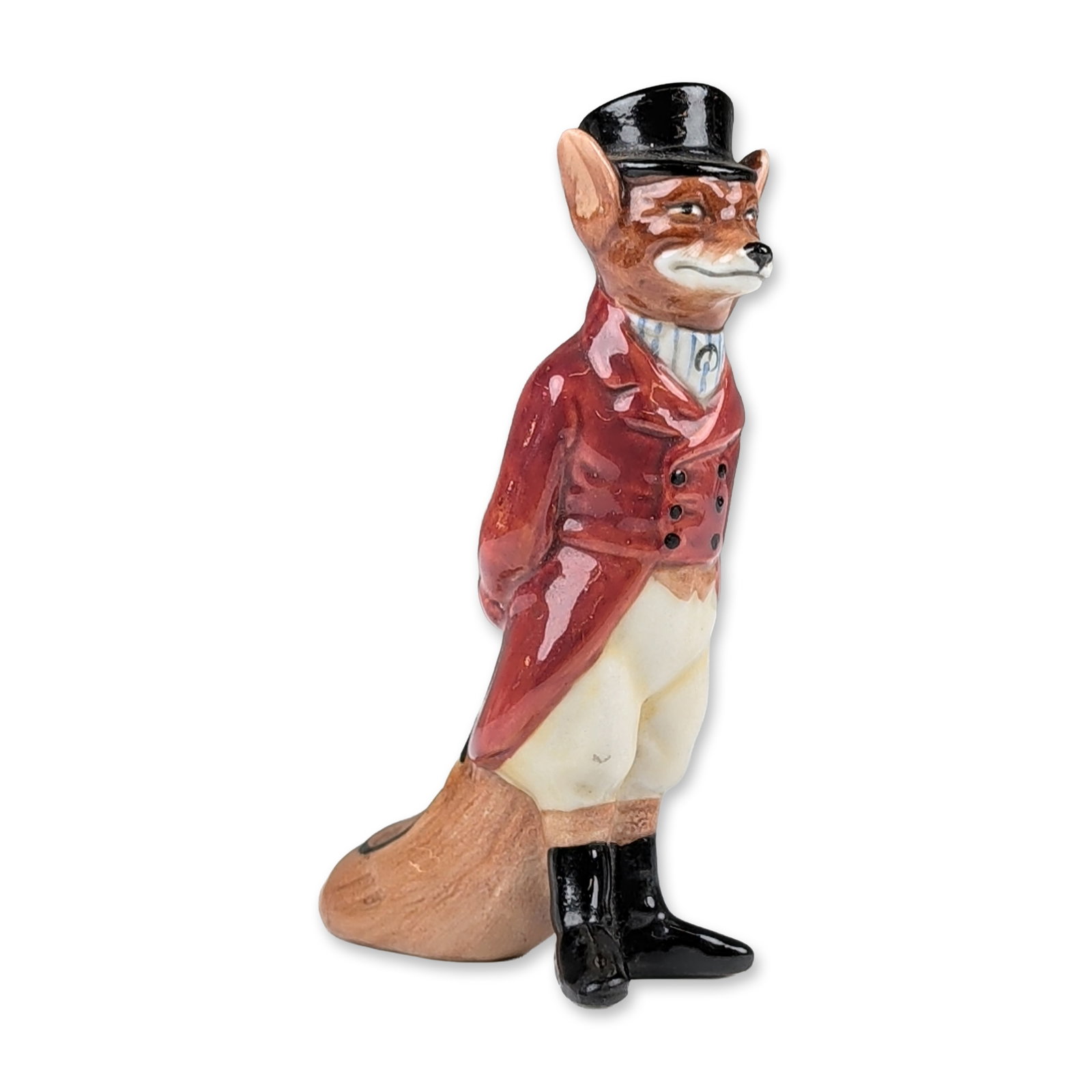 Royal Doulton Porcelain Animal Study Figurine, Huntsman Fox D6448: Depicting an anthropomorphic fox in traditional British hunting attire. The figure is modeled wearing a scarlet hunting coat over a blue and white striped waistcoat, white cravat, and cream-colored br