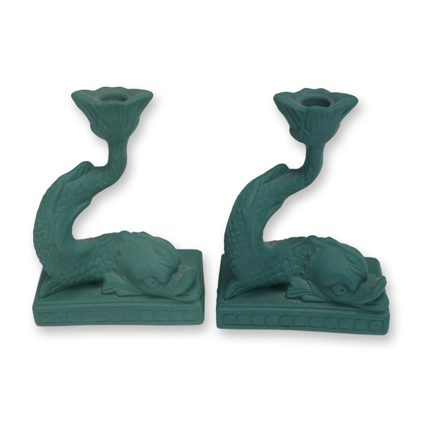 Pair of Wedgwood Sage Green Jasperware Dolphin Candle Holders: This pair of Wedgwood jasperware figural candle holders is rendered in a sage green hue. Each piece is modeled as a stylized dolphin with a curved body set upon a rectangular tiered plinth. The plinth