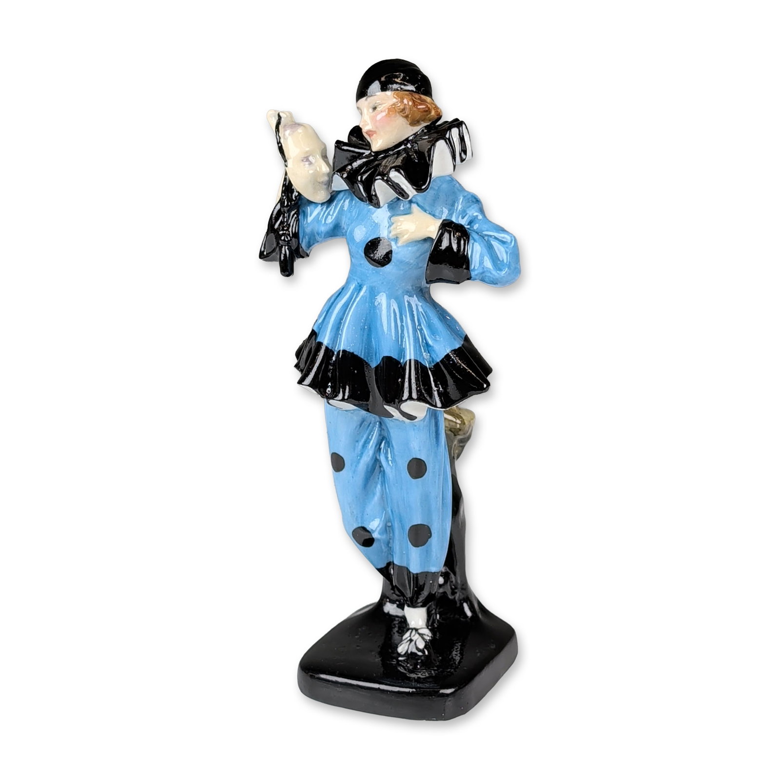 Royal Doulton Colorway Porcelain Art Deco Figurine, The Mask: Designed by Leslie Harradine, featuring a female figure in a blue and black Pierrette costume holding a white theatrical mask and a small child figure to the reverse. The underside is marked with a ha