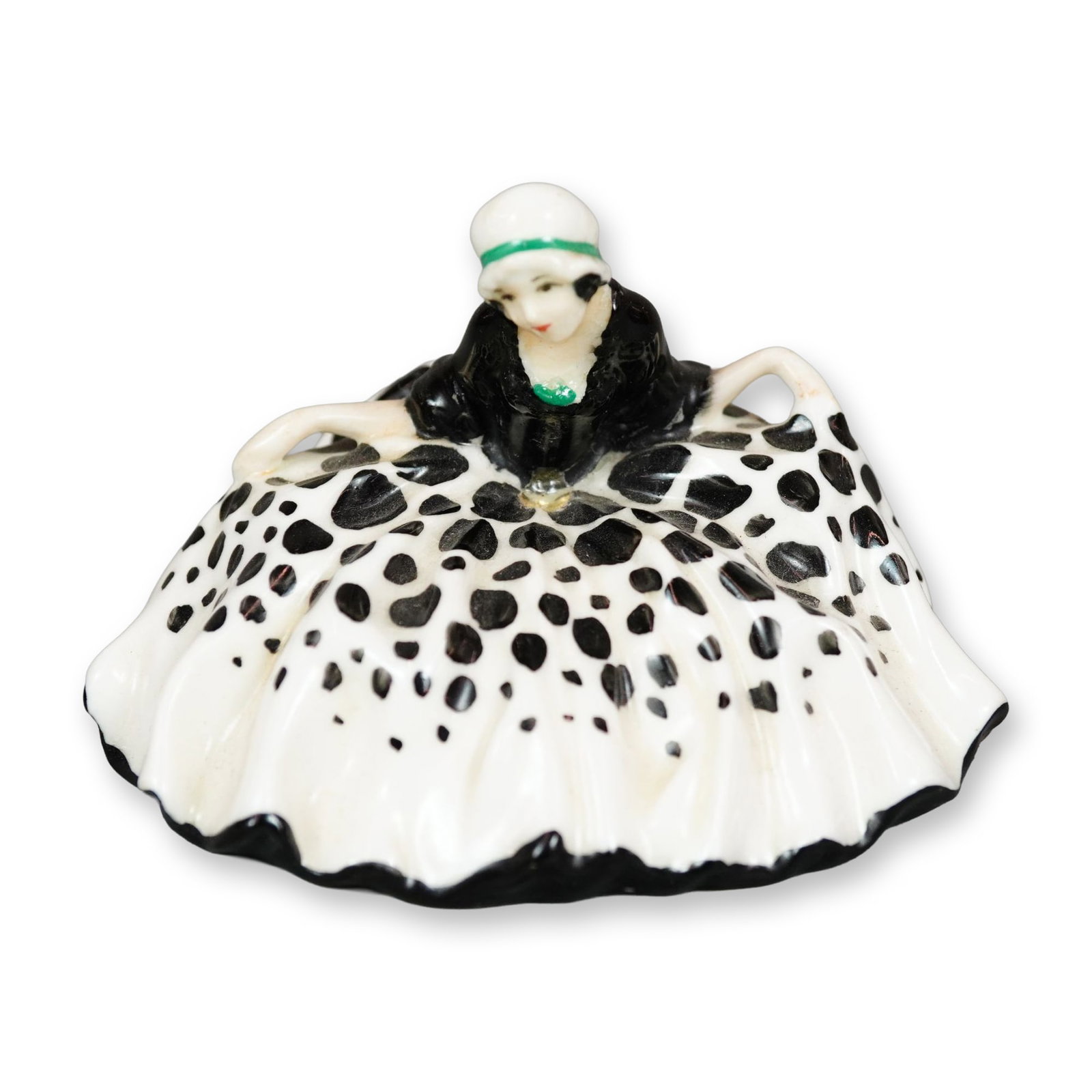 Royal Doulton Colorway Figurine, Polly Peachum: Character from "The Beggar's Opera", the figure depicts a young woman curtsying. She is shown wearing a white dress with black spots. This figure was once part of a base. Royal Doulton backstamp. Dime