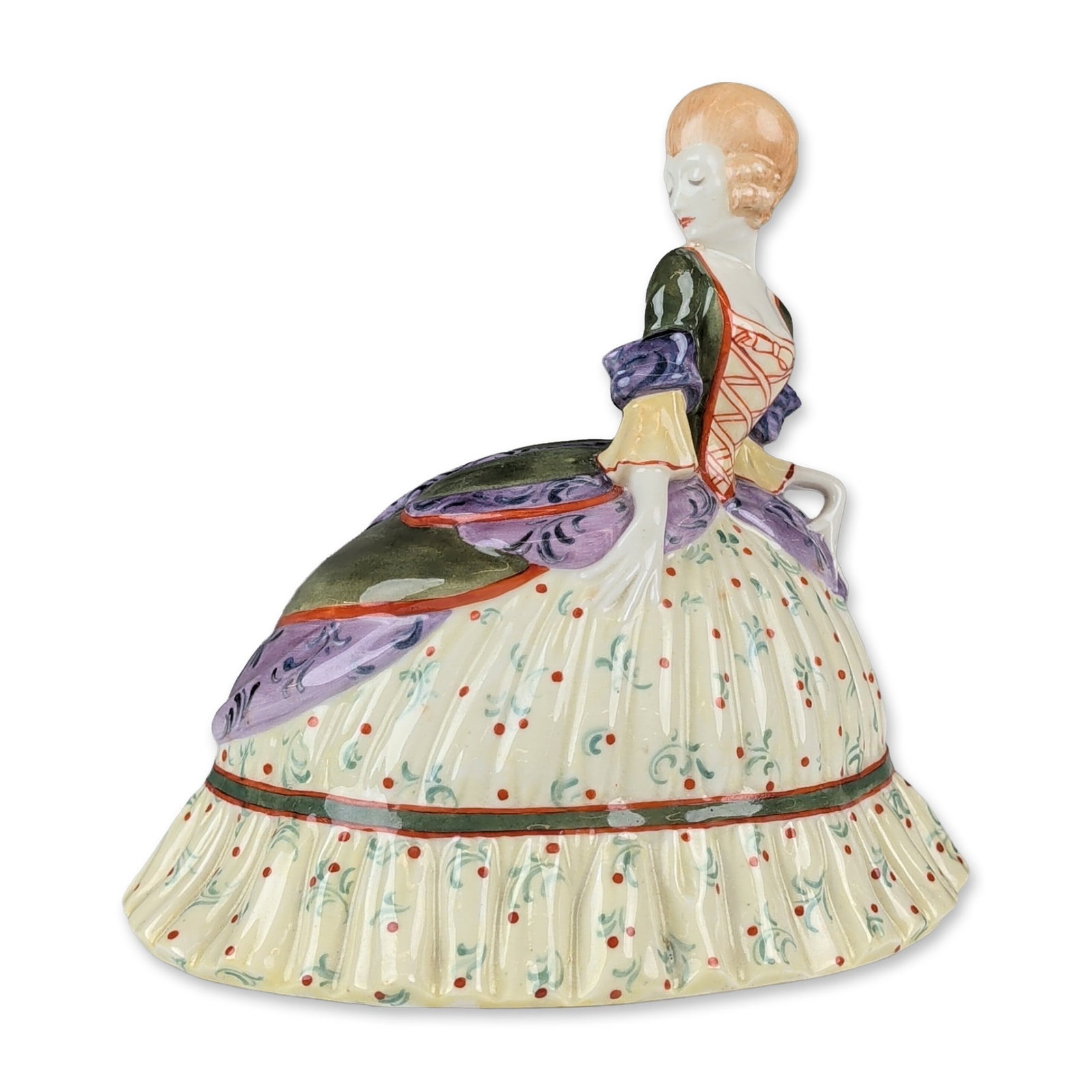 Royal Doulton Unique Colorway Porcelain Figurine, Puff and Powder: Depicting a woman in mid-18th century style attire. The figure is modeled with a wide pannier gown featuring a cream ground decorated with floral red polka dots and green foliate sprigs. The overskirt