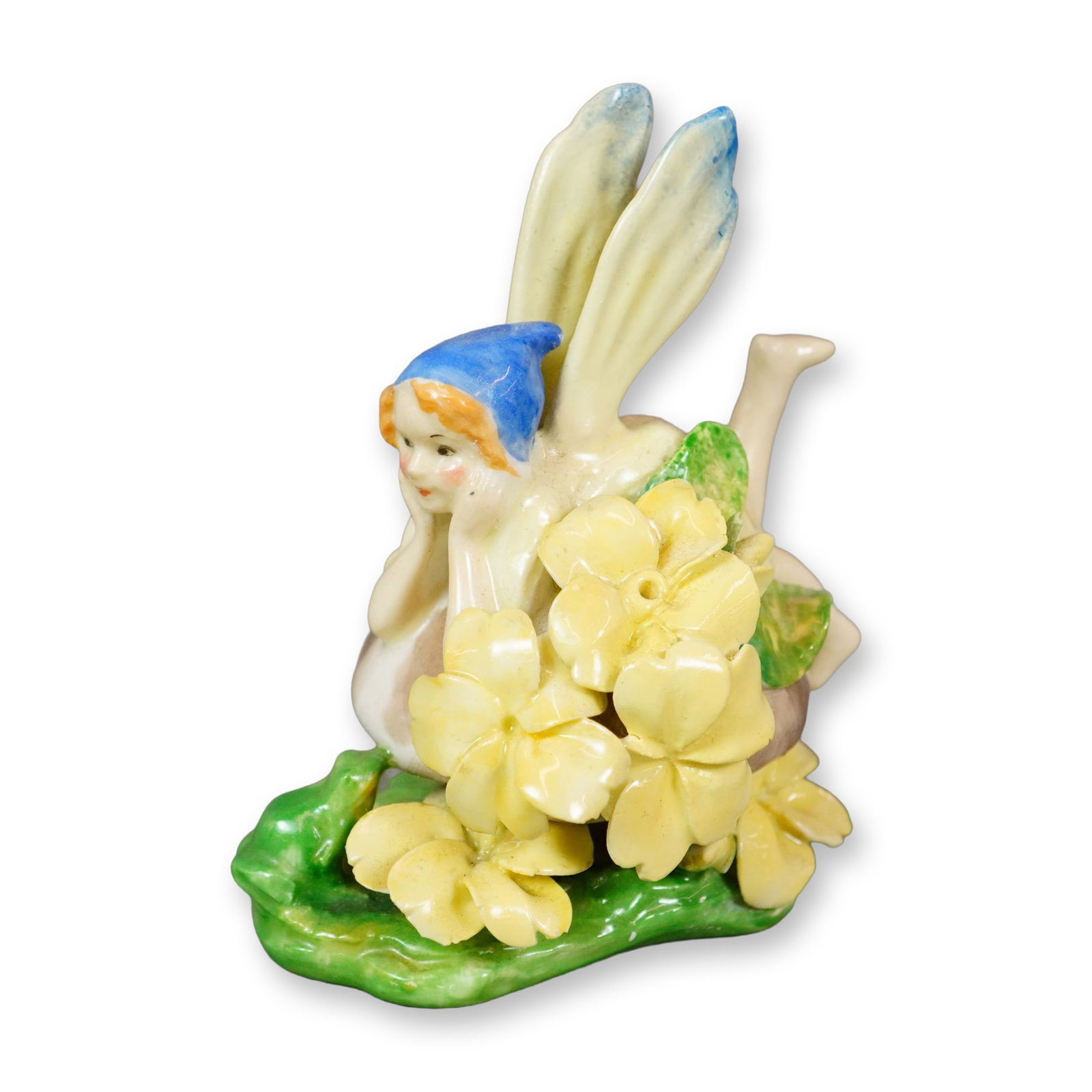 Doulton Porcelain Figurine, Fairy HN1375: Harradine Fairy Series. Fairy laying on mushroom surrounded by yellow flowers. Doulton mark. Artist: Leslie Harradine Dimensions: 3"L x 2.25"W x 3.5"H Manufacturer or Brand: Doulton Country of Origin: